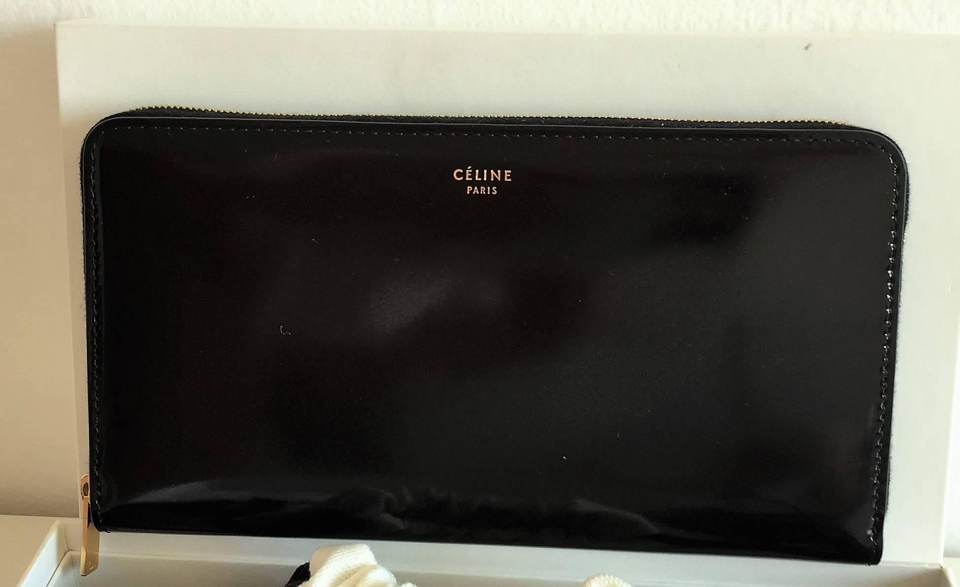 Céline Large Zipper Wallet in Vernis Black Leather, New unworn item with tag. This Zippy wallet has twelve card slots, one zipped pocket and two gusset pockets for notes. Certificate of authenticity, dust bag and box are included. 

Condition: New
