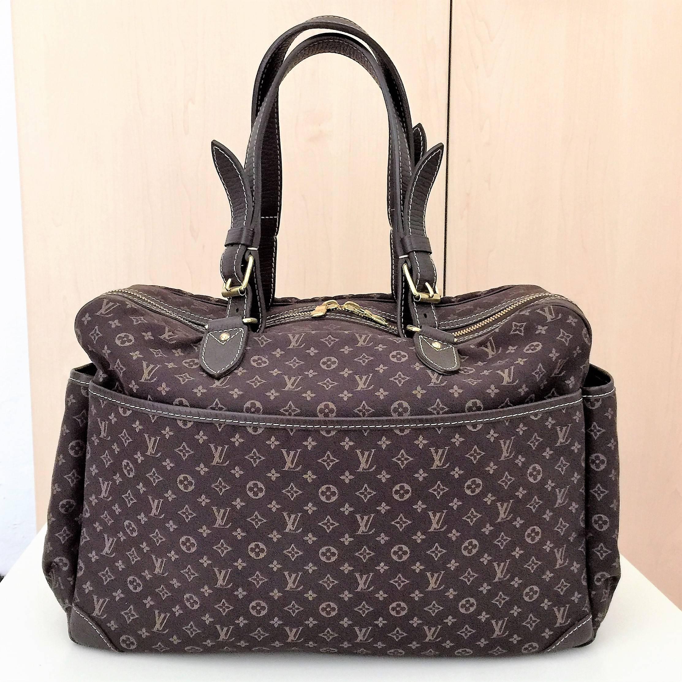 This authentic Louis Vuitton mini diaper Mini Lin Sac a Langer Diaper bag features ebene brown monogram mini lin canvas  (58% cotton, 24% linen, and 18% polyamide). The bag has leather adjustable handles, two zippered pockets on the front and a