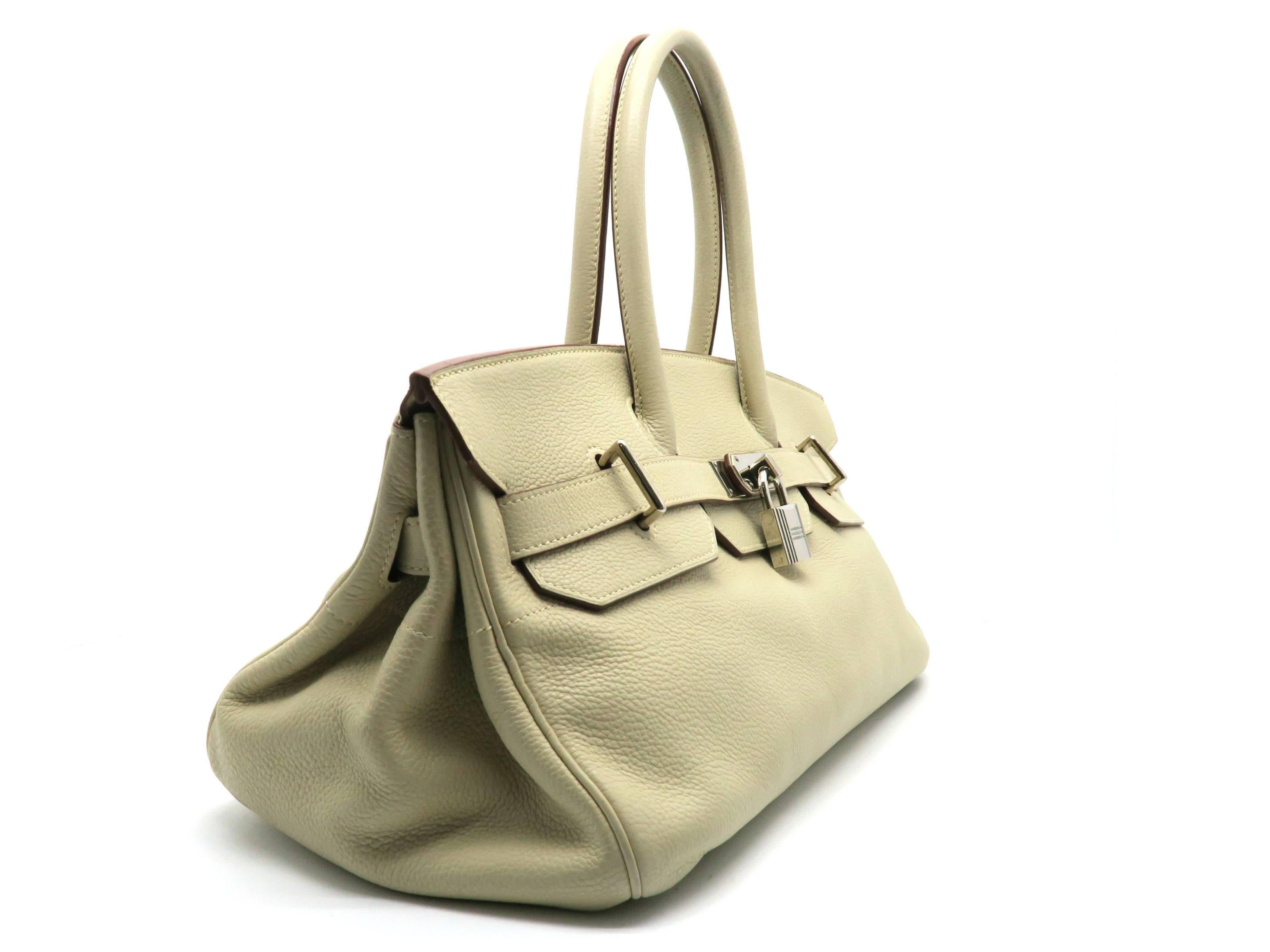 Color: Beige / Jaune Poussin (designer color) 

Material: Clemence Leather 

Condition: Rank A 
Overall: Good, few minor defects. 
Surface: Good 
Corners: Minor Scratches & Stains
Edges: Minor Stains
Handles/Straps: Minor Scratches & Stains