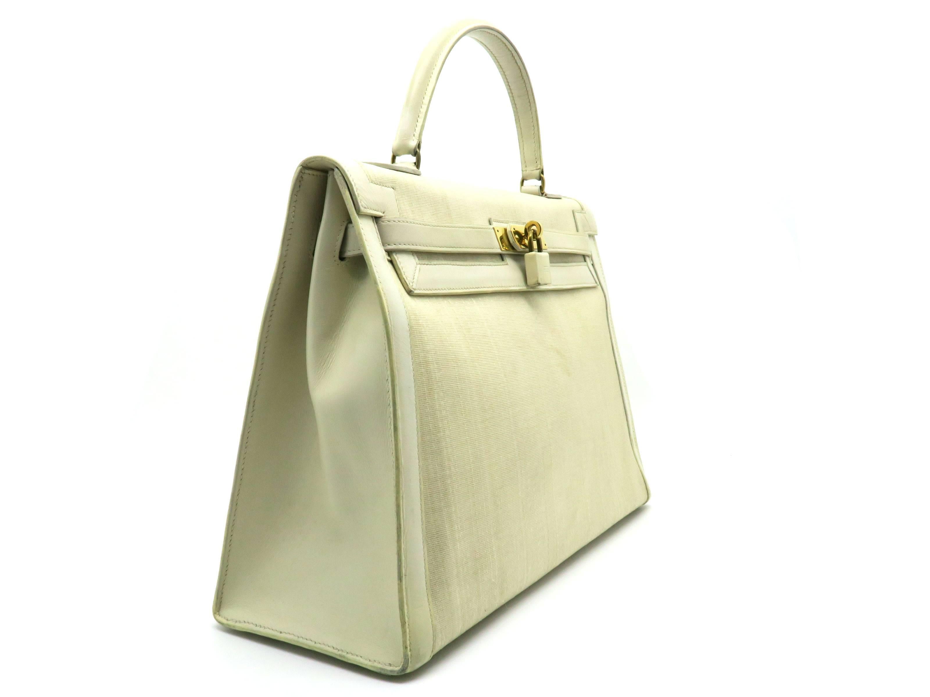 Color: Beige / Jaune Poussin (designer color) 

Material: Box Calf Leather and Canvas

Condition: Rank C 
Overall: Poor. Serious Defects. 
Surface: Obvious Scratches & Stains
Corners: Obvious Scratches & Stains
Edges: Minor Scratches &