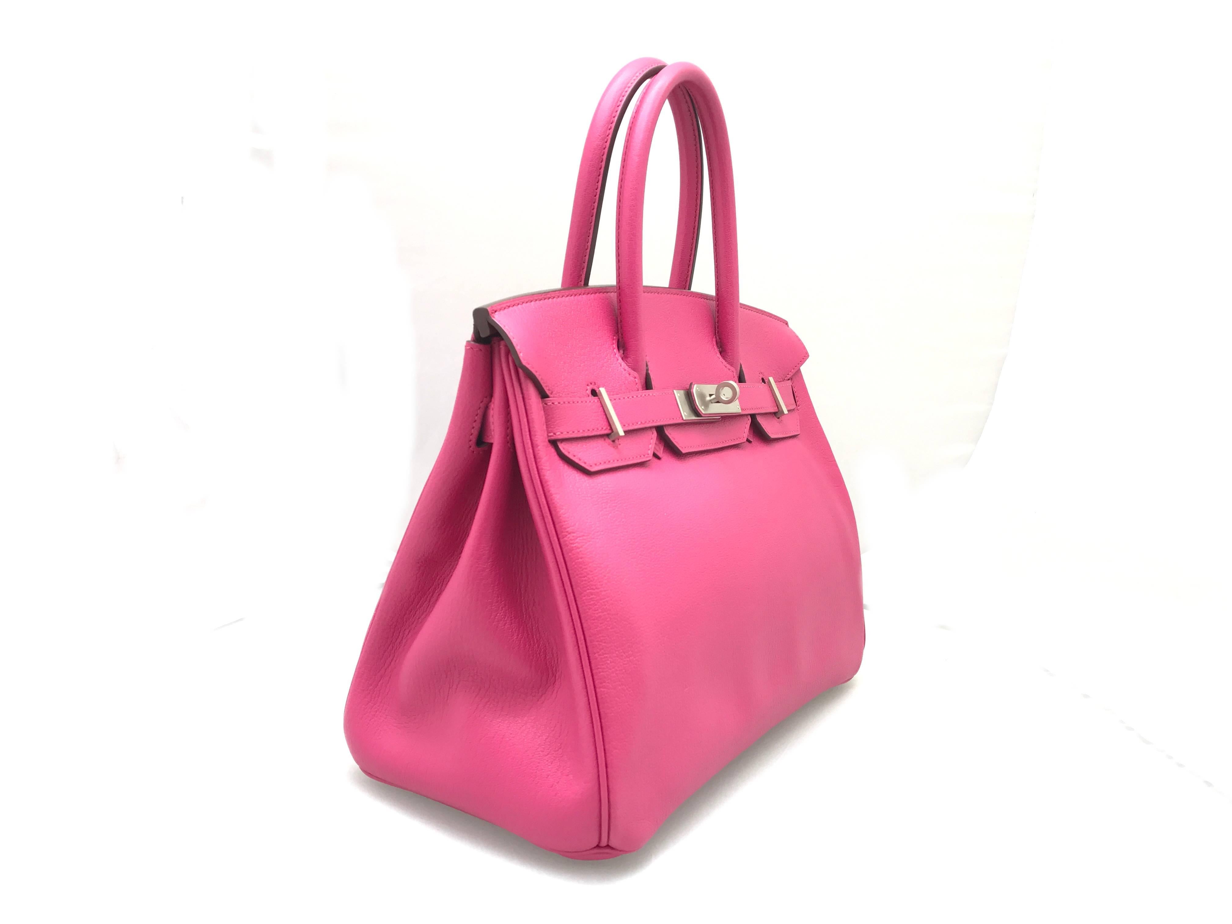 Color: Pink / Rose Tyrien (designer color) 

Material: Chevre Leather 

Condition: Rank A 
Overall: Good, few minor defects. 
Surface: Minor Scratches
Corners: Obvious Scratches 
Edges: Minor Scratches
Handles/Straps: Minor Scratches
Hardware: Minor