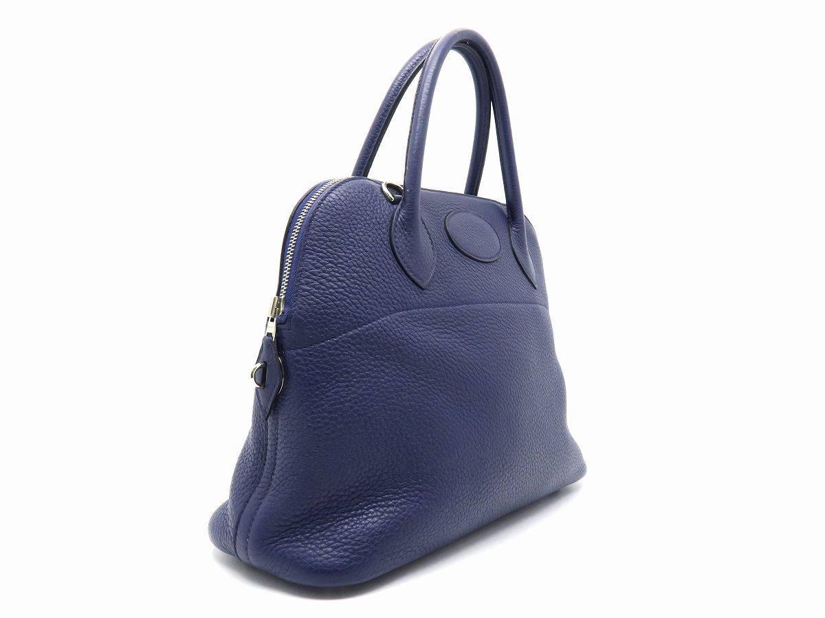 Color: Blue / Bleu Saphir (designer color) 

Material: Clemence Leather

Condition: Rank B 
Overall: Fair. Few defects
Surface: Good
Corners: Obvious Scratches
Edges: Good
Handles/Straps: Good
Hardware: Minor Scratches

Dimension: W31 × H24 ×