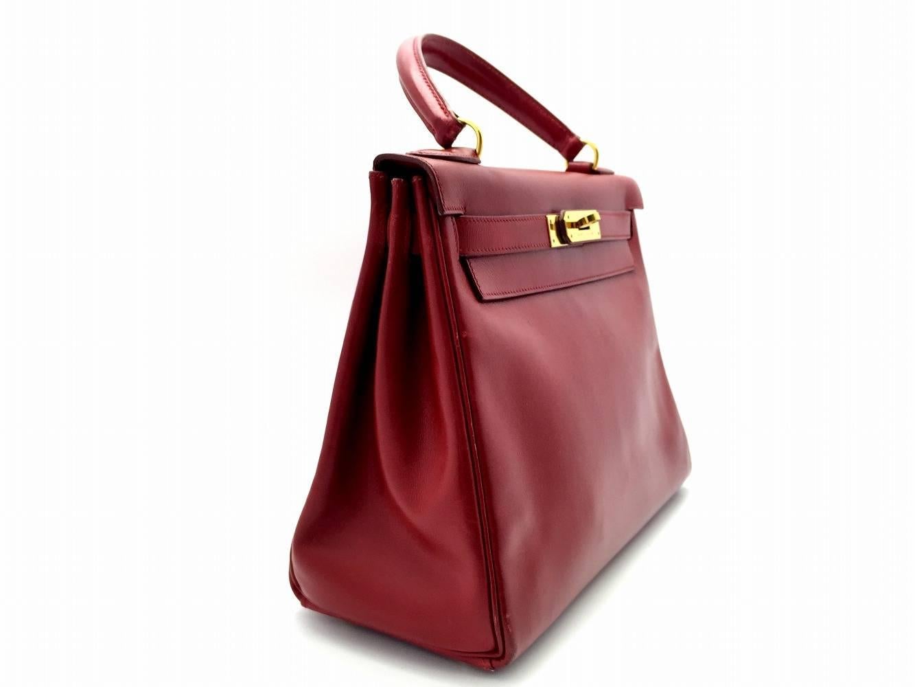 Color: Red / Rouge Garance (designer color) 

Material: Box Calf Leather

Condition: Rank A 
Overall: Good, few minor defects
Surface: Minor Stains
Corners: Minor Stains & Stains
Edges: Minor Stains & Stains
Handles/Straps: Minor Stains