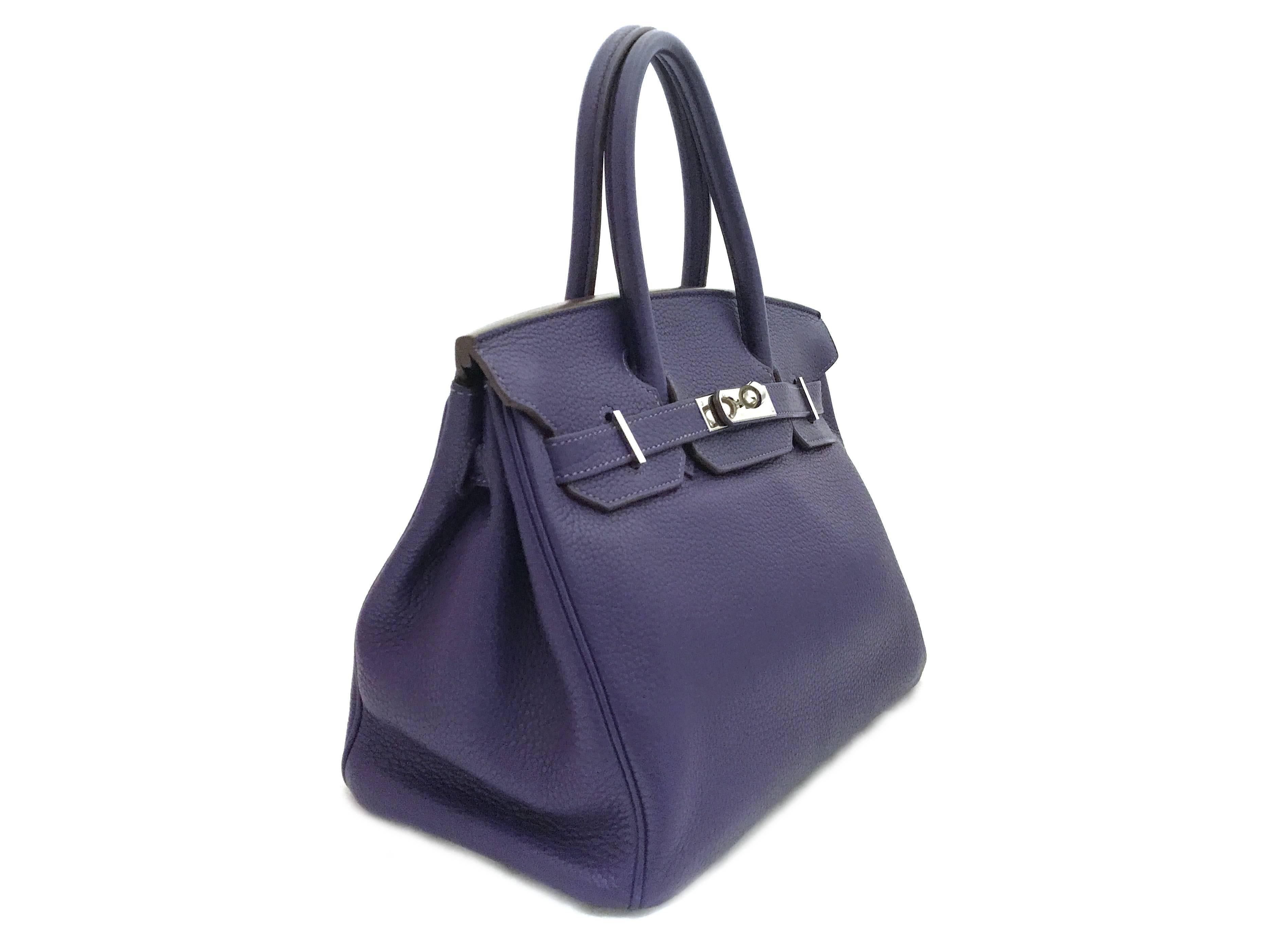 Color: Purple / Iris (designer color) 

Material: Togo Leather

Condition: Rank A 
Overall: Good, few minor defects
Surface: Good
Corners: Minor Scratches
Edges: Good
Handles/Straps: Good
Hardware: Minor Scratches

Dimension: W30 × H19 ×