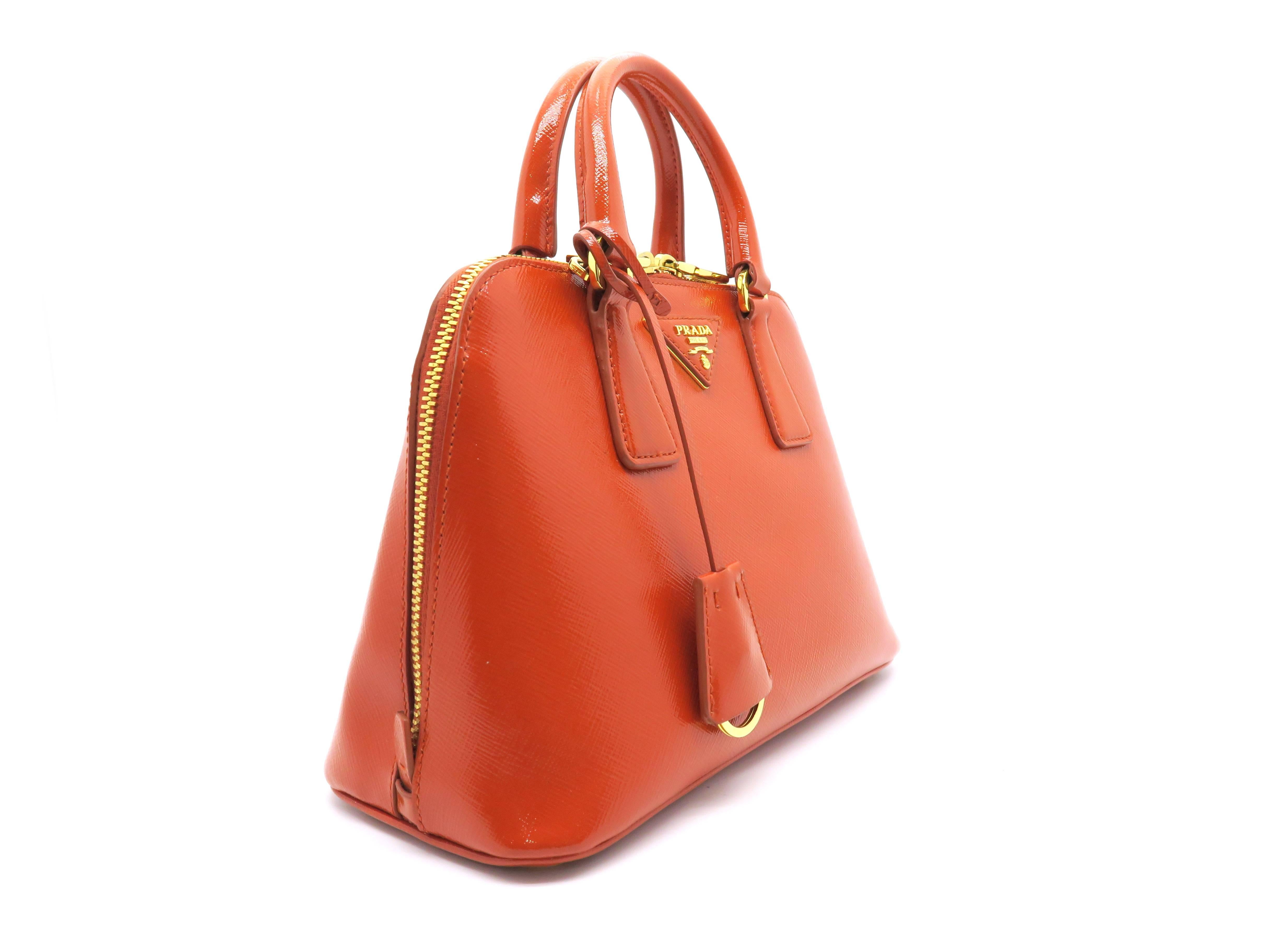 Color: Orange

Material: Saffiano Leather

Condition: Rank A
Overall: Good, few minor defects
Surface: Good
Corners: Minor Scratches 
Edges: Good
Handles/Straps: Good
Hardware: Minor Scratches

Dimensions: W25×H17×D11cm
Handles: 24cm
Shoulder Strap: