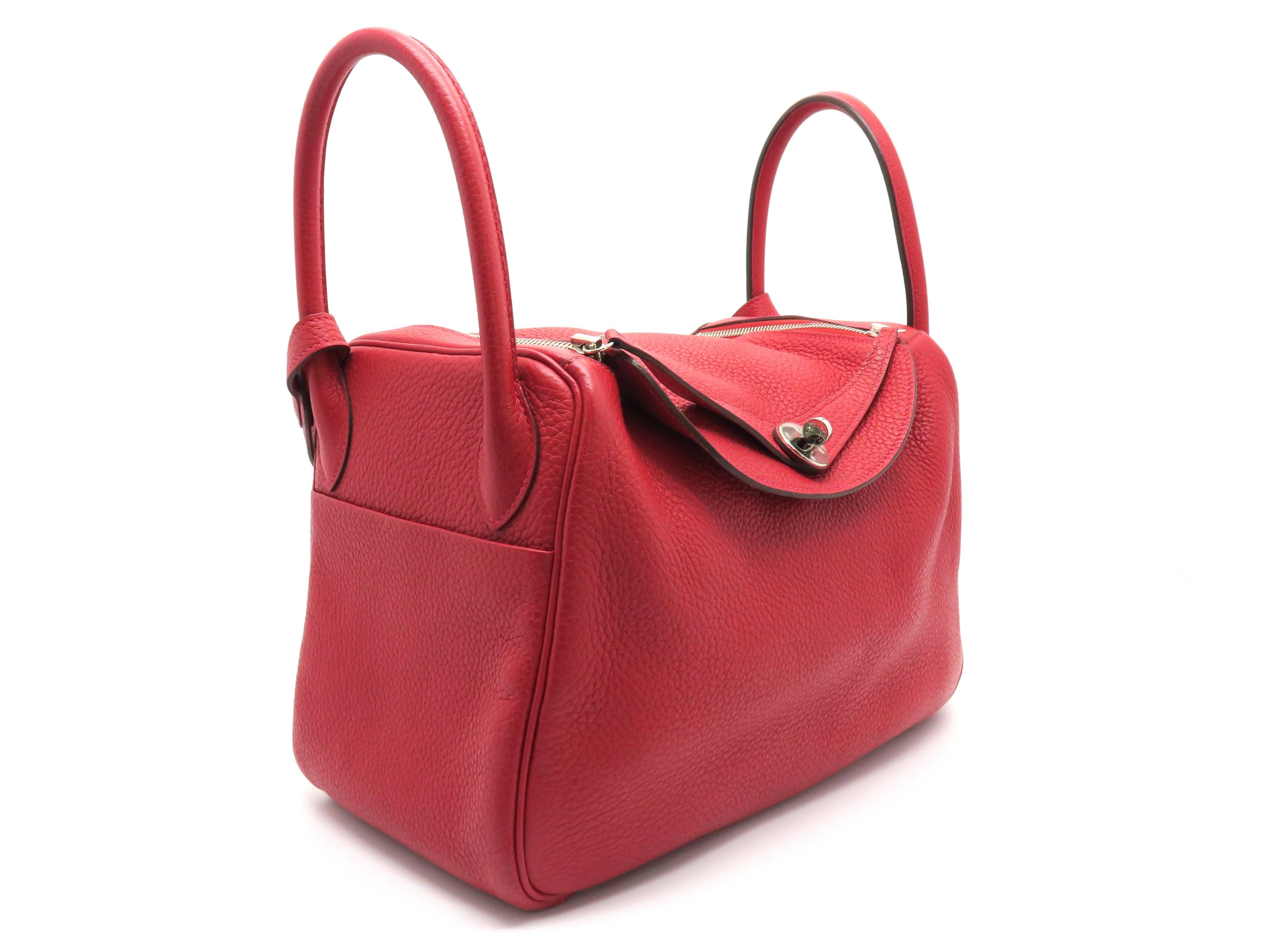 Color: Rouge Garance (designer color)

Material: Taurillon Clemence Leather

Condition: Rank A
Overall: Good, few minor defects.
Surface: Good
Corners: Good
Edges: Good
Handles/Strap: Minor Scratches
Hardware: Good

Dimensions: