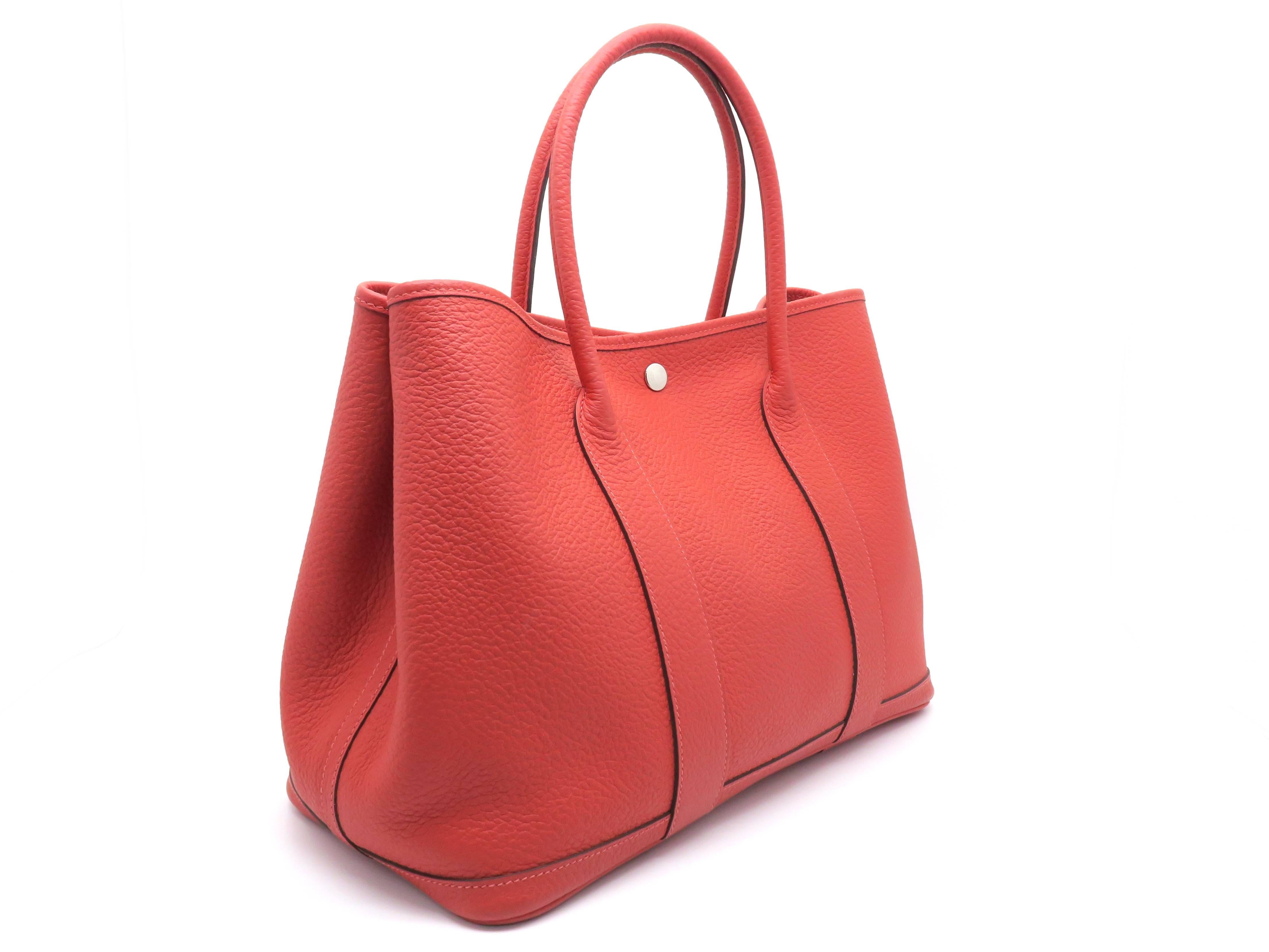 Color: Rouge Pivoine ( Design Color ) /Red

Material: Country Leather

Condition: Rank B 
Overall: Fair. Few defects
Surface: Good
Corners: Obvious Stains
Edges: Minor Stains
Handles/Straps: Good
Hardware: Minor Scratches

Dimension: W36 × H26 ×
