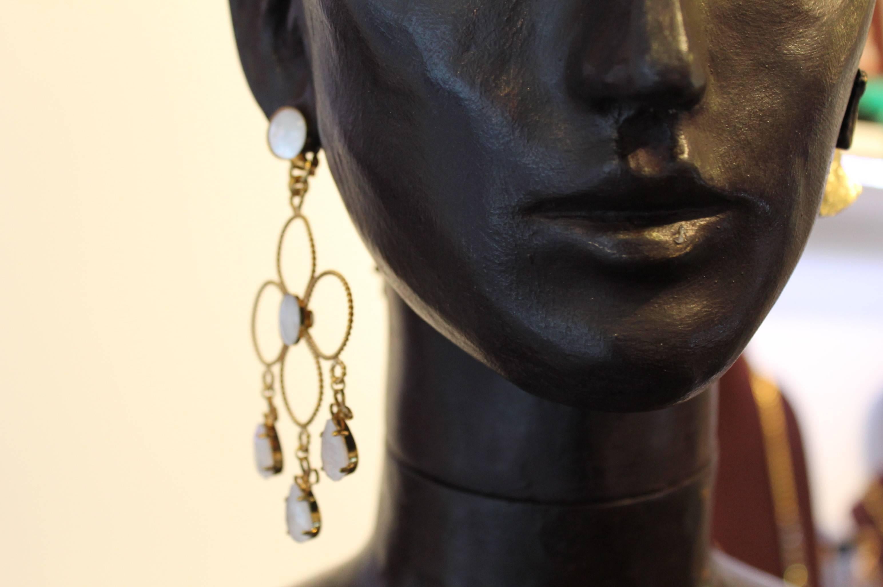 Bold yet delicate.

Floral outline geometric shape in twisted 23ct gold-plated wire, highlighted with mother-of-pearl and  opaque white Swarovski crystals.

Please note these earrings are clips.

Handmade for the past 25 years by Vicki’s small team