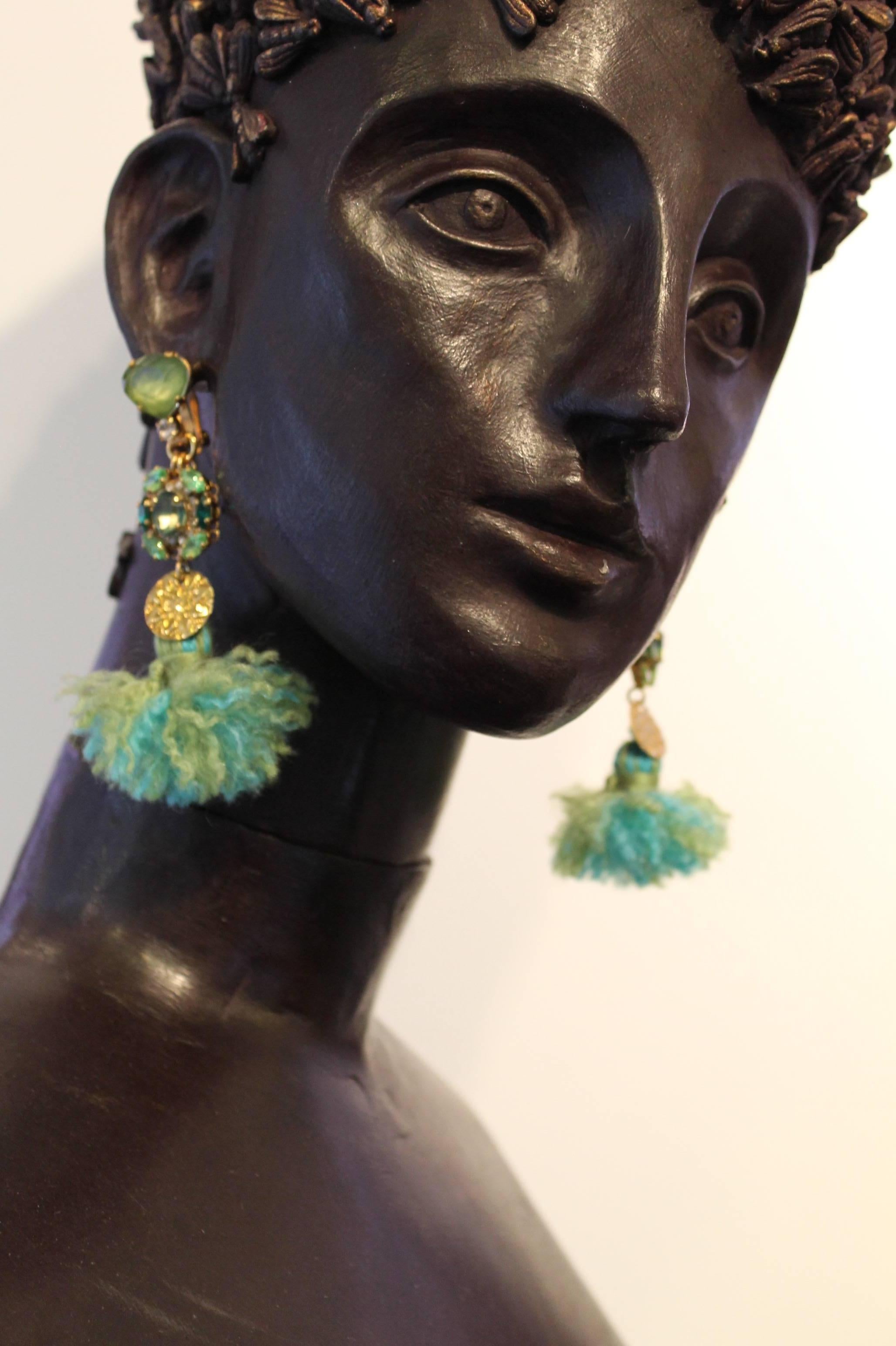 Fun and modern.

Hand-combed woollen tassels in gorgeous shades of green with  clear and green Swarovski crystals and gold-plated coins.

Fun, modern tassel statement drop earrings. Surprising light and easy to wear.

Please note these earrings are