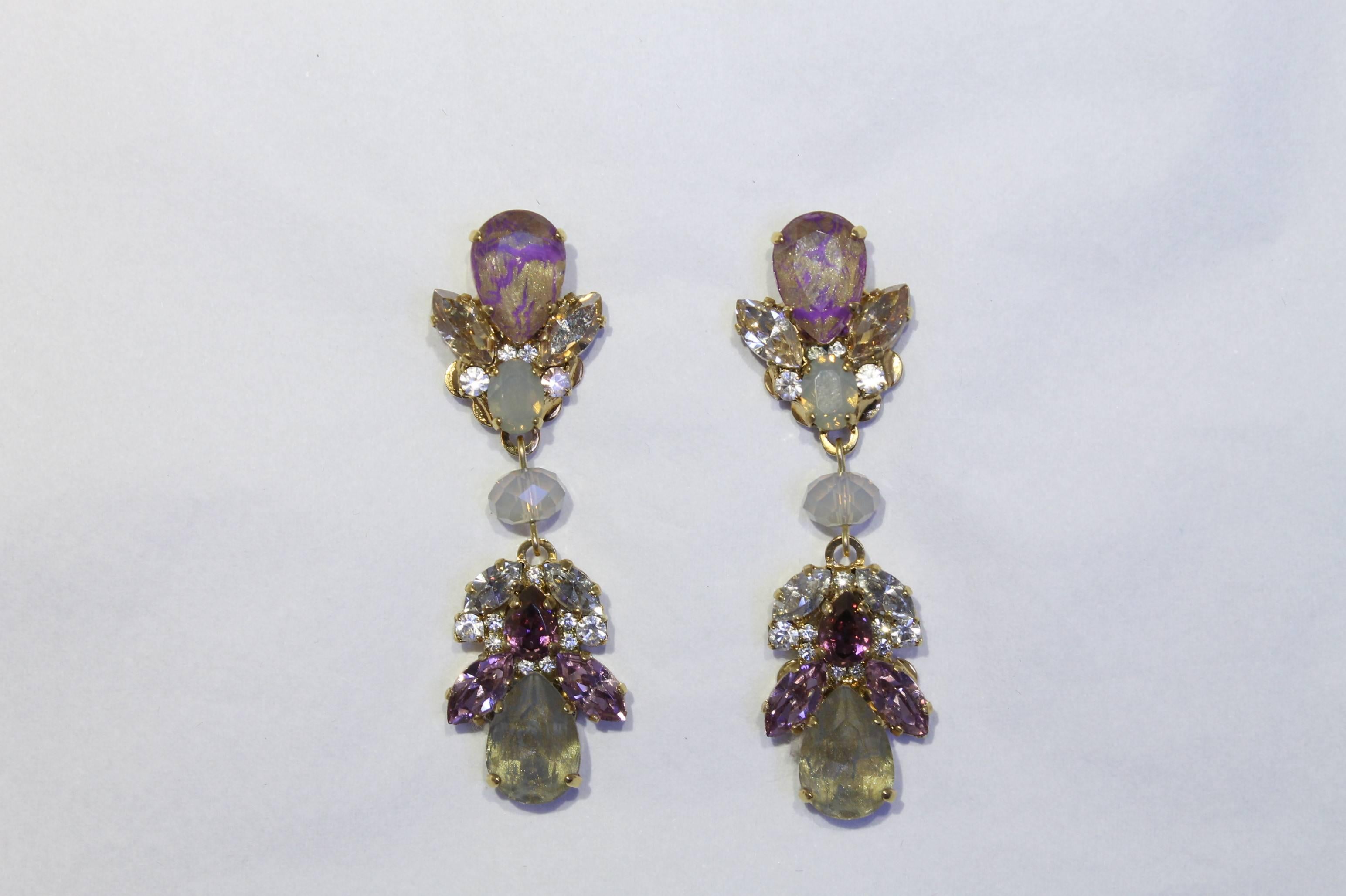 Romantic shades of gold, opal, purple and clear Swarovski crystals. Charming chandelier earrings, with uniquely hand-enamelled purple and gold Swarovski crystals, these really are perfect for elegant summer evenings.

Handmade for the past 25 years