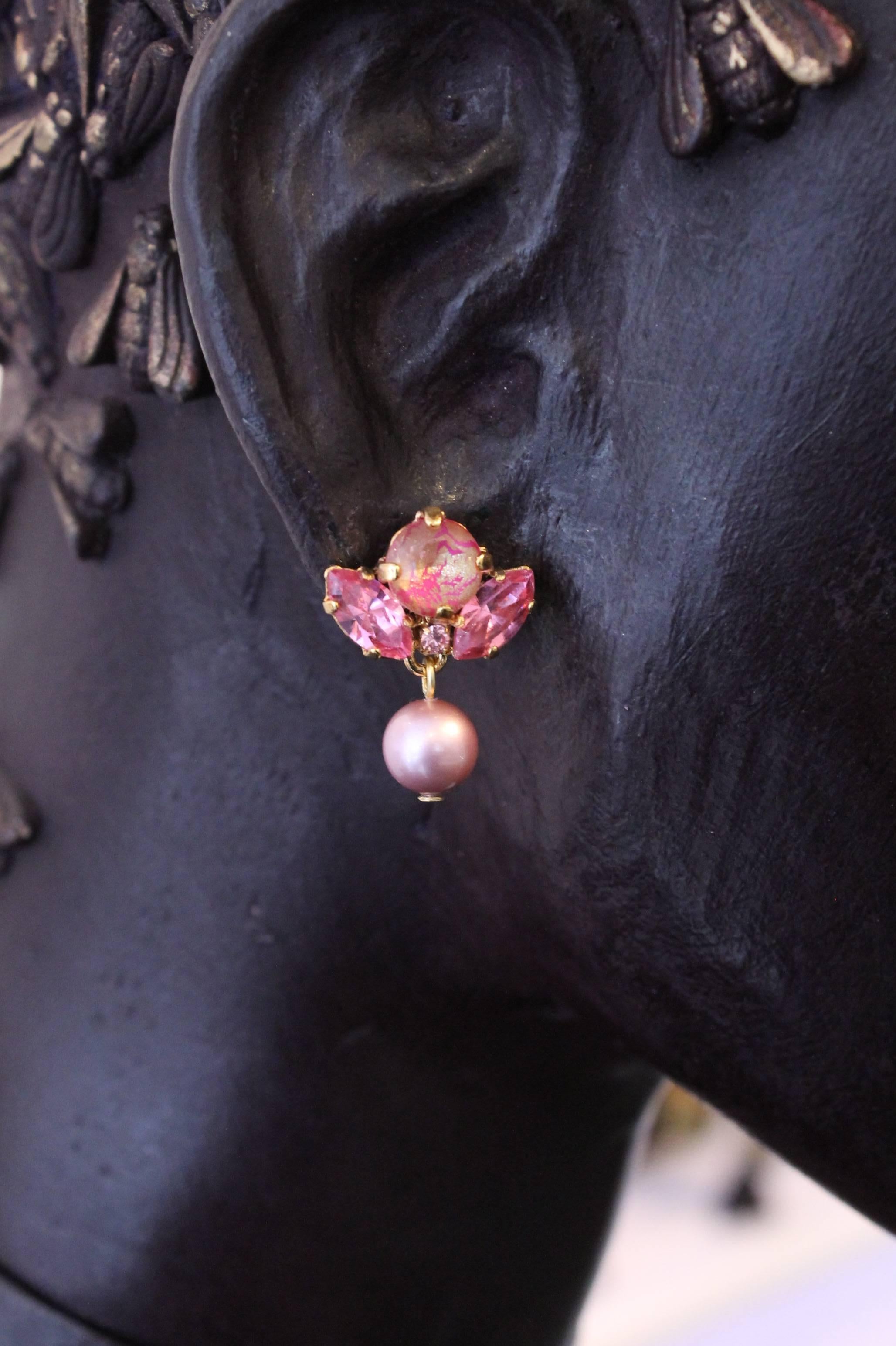 One-of-a-kind delicate drop earrings, featuring hand-enamelled Swarovski crystals, making each earring utterly unique. 

This small, charming style is flattering to all - and this stunning combination of pink Swarovski crystals, pink pearls and gold