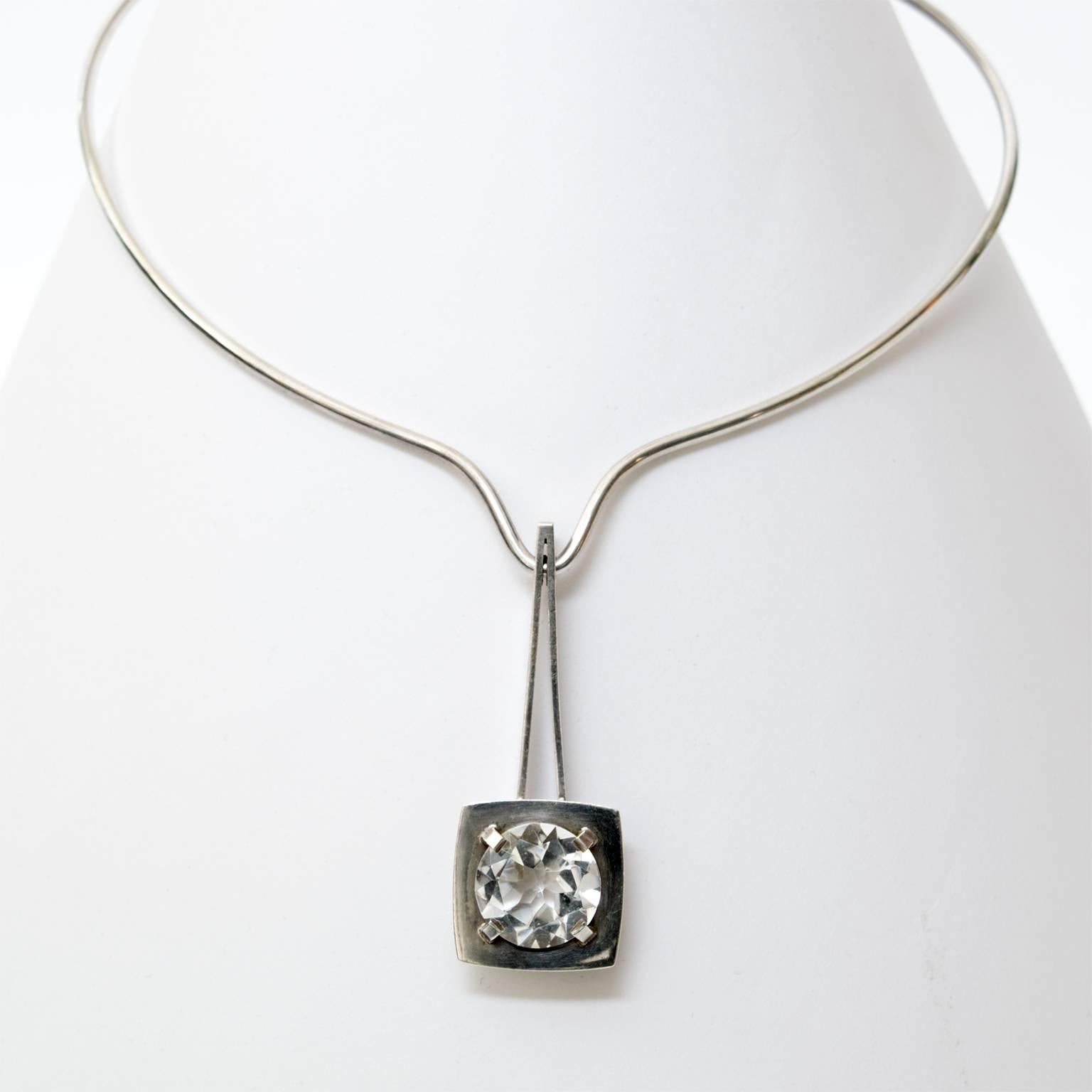 Silver necklace with a pendant holding a faceted rock crystal. Designed by Sven Haugaard, Denmark.