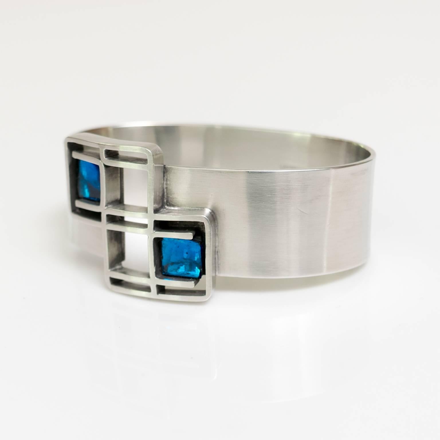 Women's Scandinavian Modern Lögeskov Tenn, polished pewter bracelet with blue glass. 