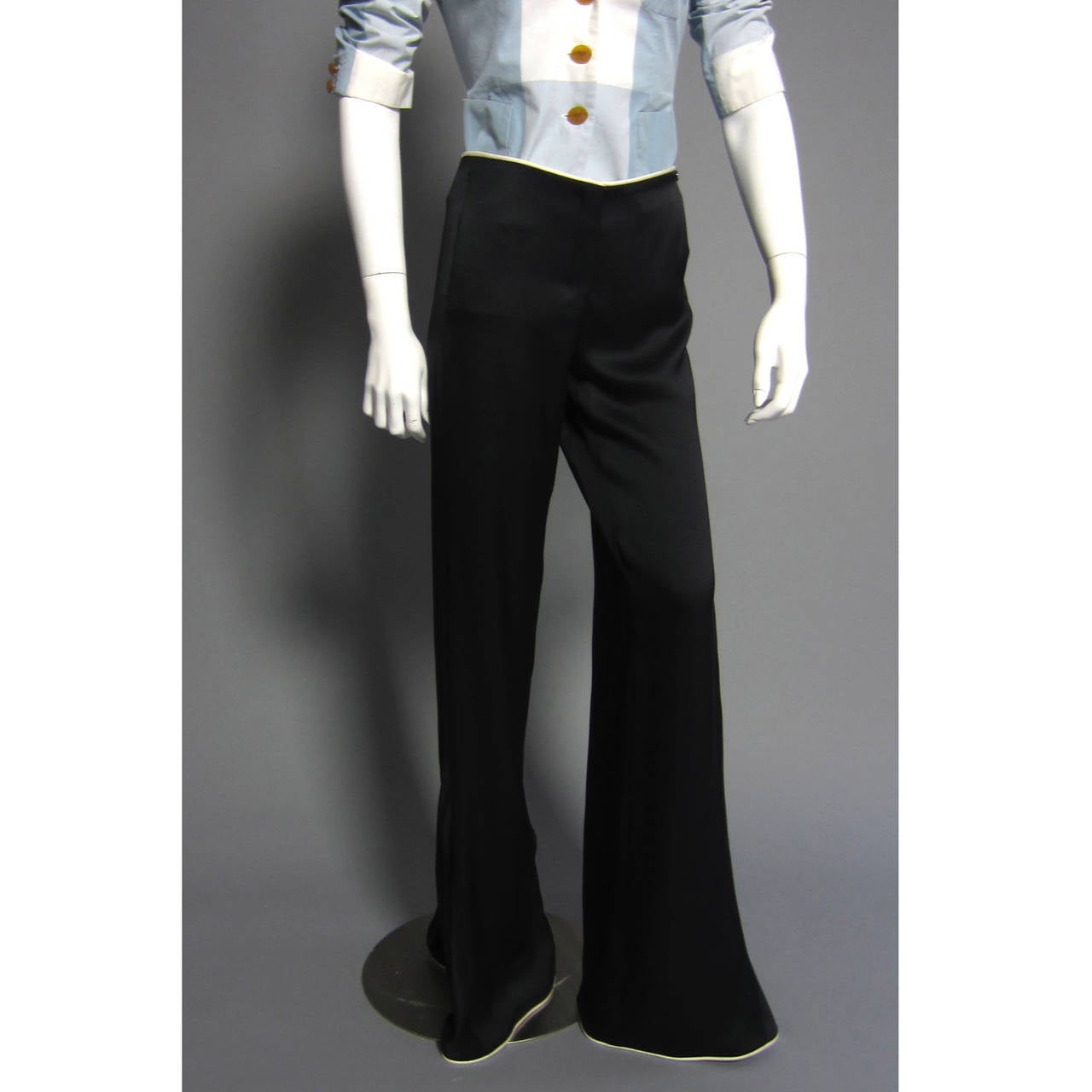 Classic, Chic, CHANEL. These silk pants are designed to sit low on the hips. An additional panel of fabric creates a wide leg.  The waist and bottom hem are trimmed in beige silk pipping. Front Zipper Closure. A small, black CC logo pendant rests