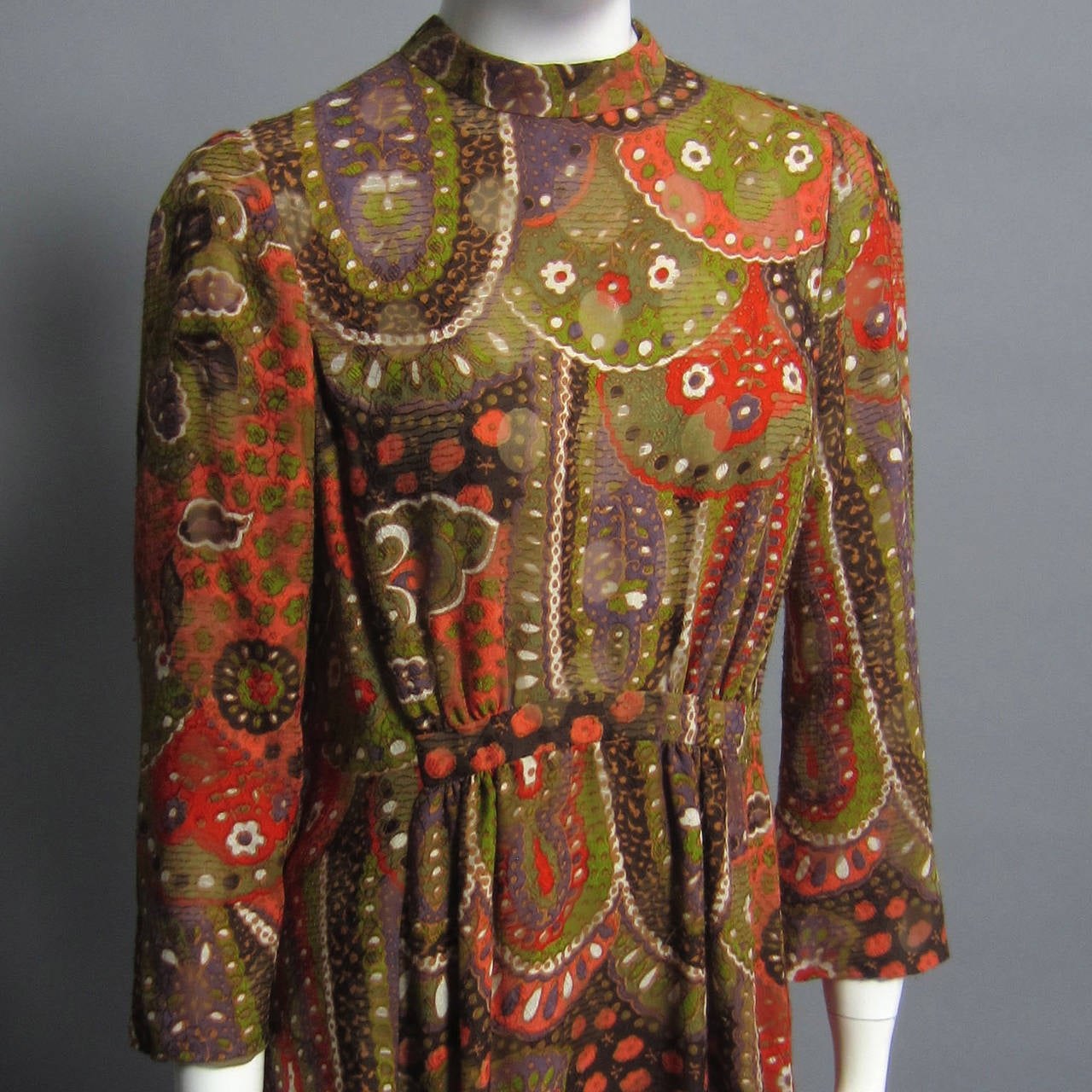 Like all PAULINE TRIGERE pieces we come across, this dress is made of exquisite fabric. The rich brown, green and orange tones create a kaleidoscope like paisley print. The bell sleeves and the a line skirt, allow for movement and show the lightness