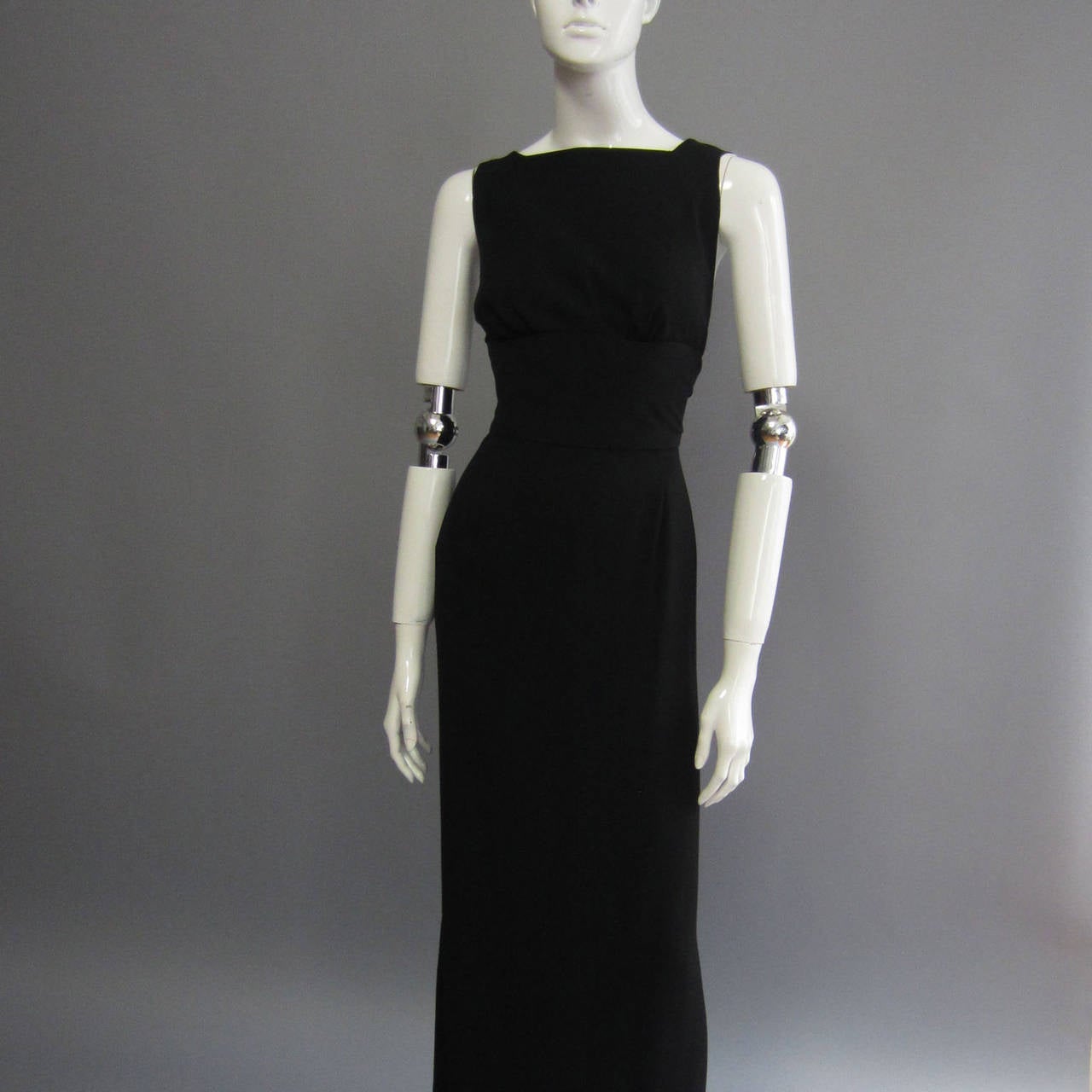 The epitome of chic, this NORMAN NORELL dress is reminiscent of the classic fashion icon Hudrey Hepburn. Its simplicity yet striking beauty makes it a timeless piece of fashion history. The black silk crepe creates a wide band at the front waist.