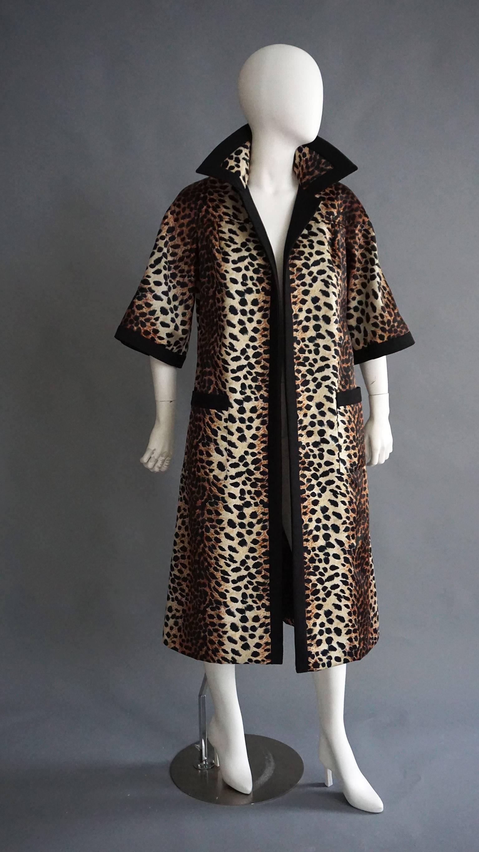 Timeless and chic, this LILLI ANNE coat is a perfect addition to any wardrobe. The gorgeous leopard print silk covers the body of the coat, including the underneath of the large color. The coat is lined in a black silk linen. This is repeated as the