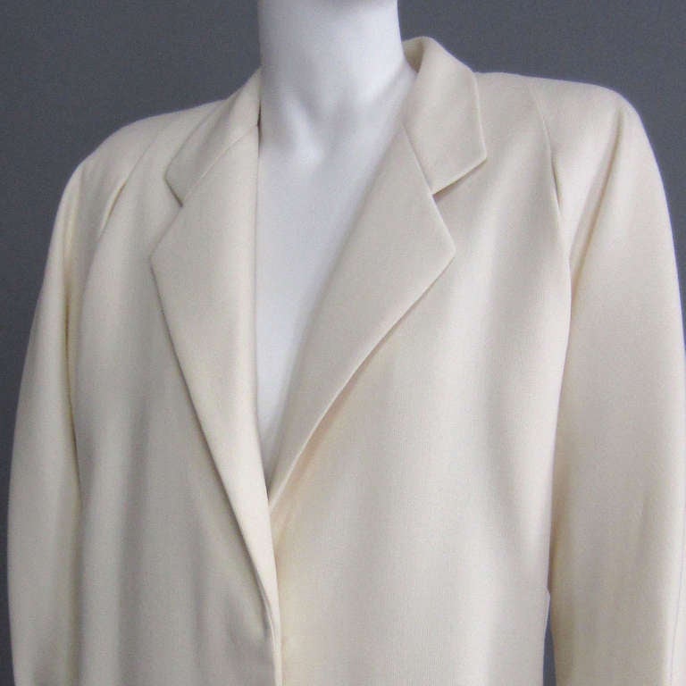 A beautiful piece from a master, this JAMES GALANOS coat is made of a complimentary off white wool. The various design details reference menswear, while the all over aesthetic retains its femininity. The lapel detail highlights the deep v neckline.