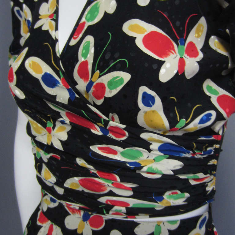 This fabulous UNGARO ensemble is comprised of a crop top and high waisted skirt; they are great together, but can also be worn separately. You get an outfit, as well as great separates with this piece. The top has a faux wrap design on the front,