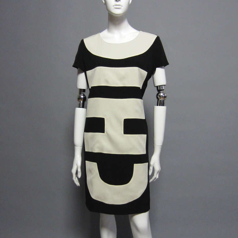 The writing on the dress says it all; this dress is C H I C. The black shift style dress is solid in back. The rounded neck is trimmed in an off white, creating the letter C. Traveling dow the letters I, H, and C, follow respectively. The dress