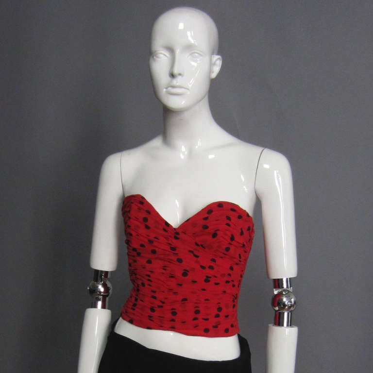 The polka dot print, silk chiffon is ruched through out the this gorgeous bustier. Sweetheart neckline. Side zipper closure. Fully lined. Excellent Condition.