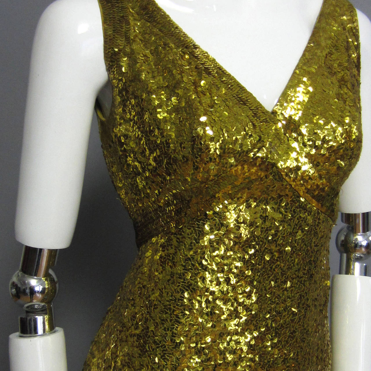 Not gold, not green, these marvelous sequins are a color in between: chartreuse is the closest color that applies. Fully covered in sequins, this LILLIE RUBIN dress is made of a stretch knit fabric and is lined in matching chartreuse chiffon. The