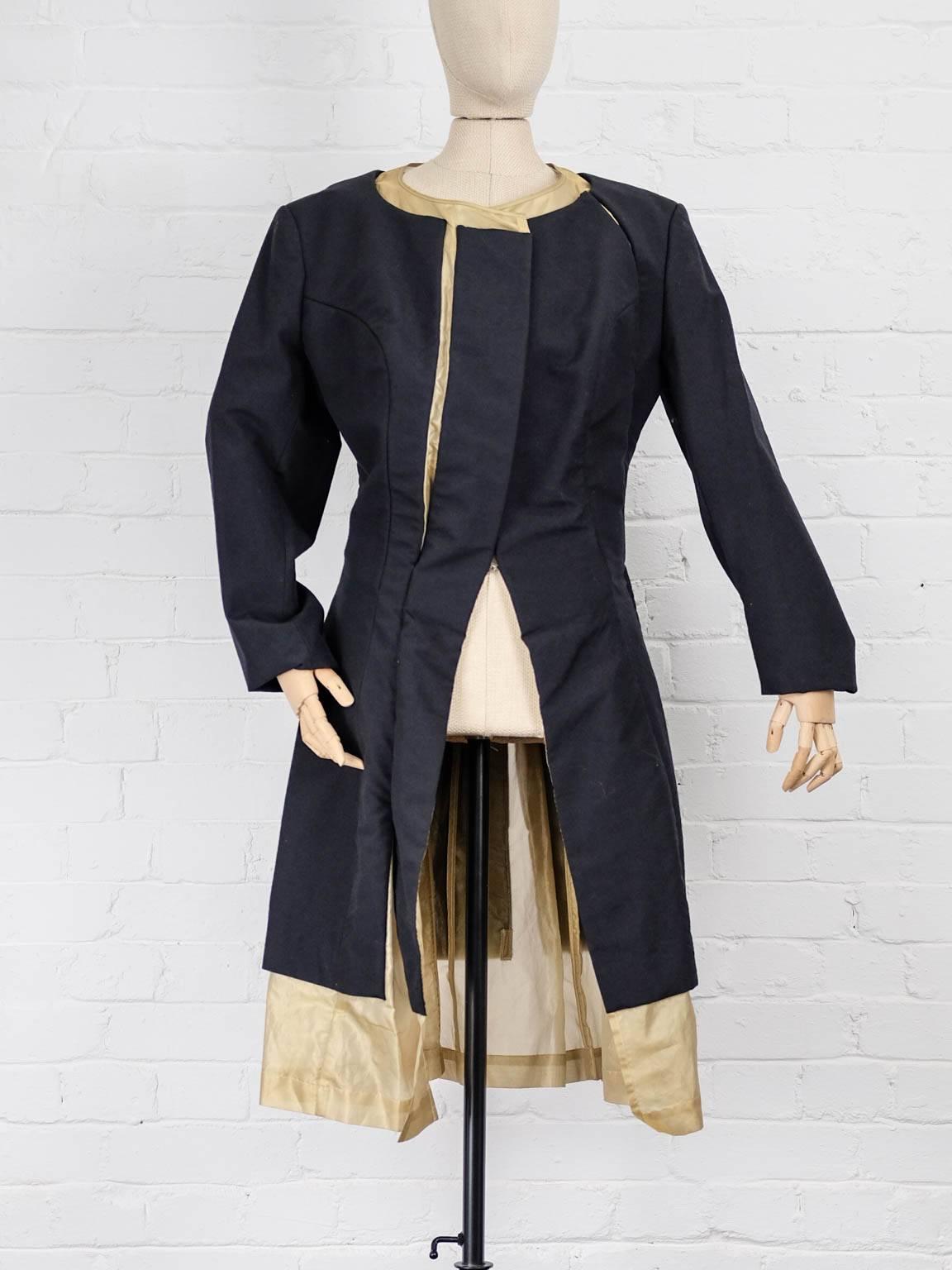 Fall 1997 Black and gold wool and silk blend layered coat, featuring a round neck, long sleeves, an open front, a mid-length, slashes and fully padded.

Total Lenght 107cm
Waist 79cm
Bust 92cm
Sleeve 62cm
Back Widht 47cm
