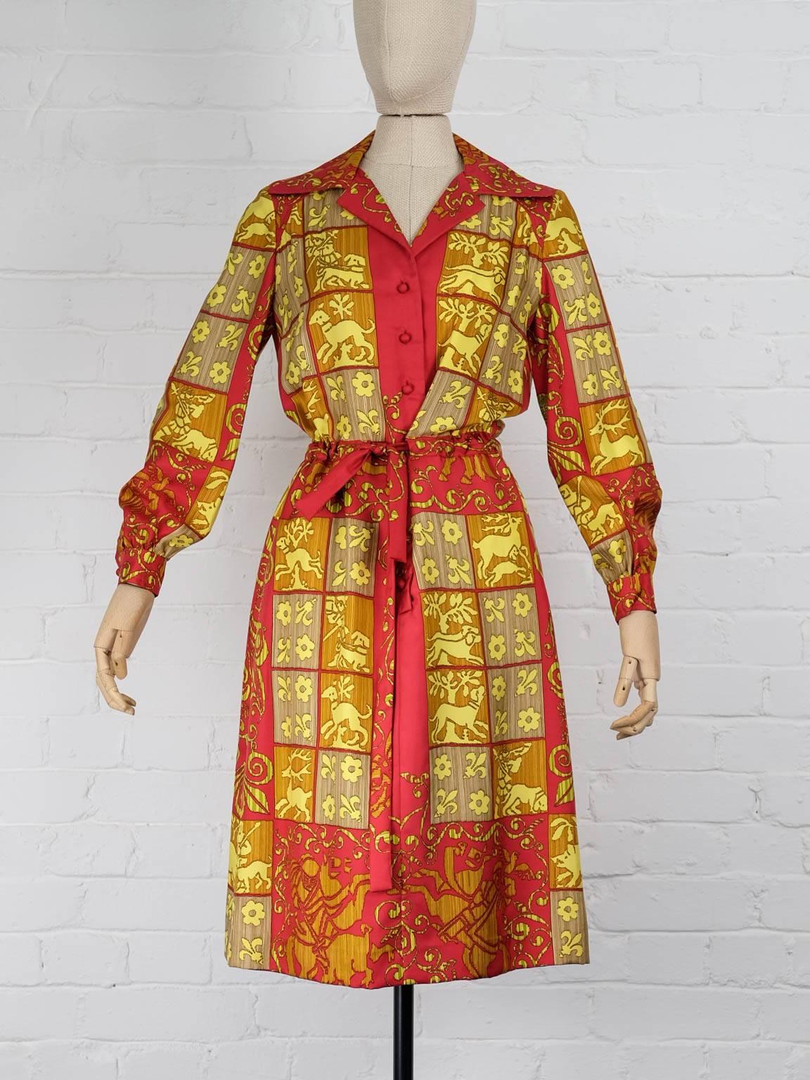 1970s Red and yellow silk baroque printed shirt dress featuring a spread collar, a front button fastening, long sleeves, button cuffs, a tie fastening and a straight hem. 
Total Lenght 104cm
Bust 90cm
Waist 86cm
Sleeve 56cm
Back Width 39cm
