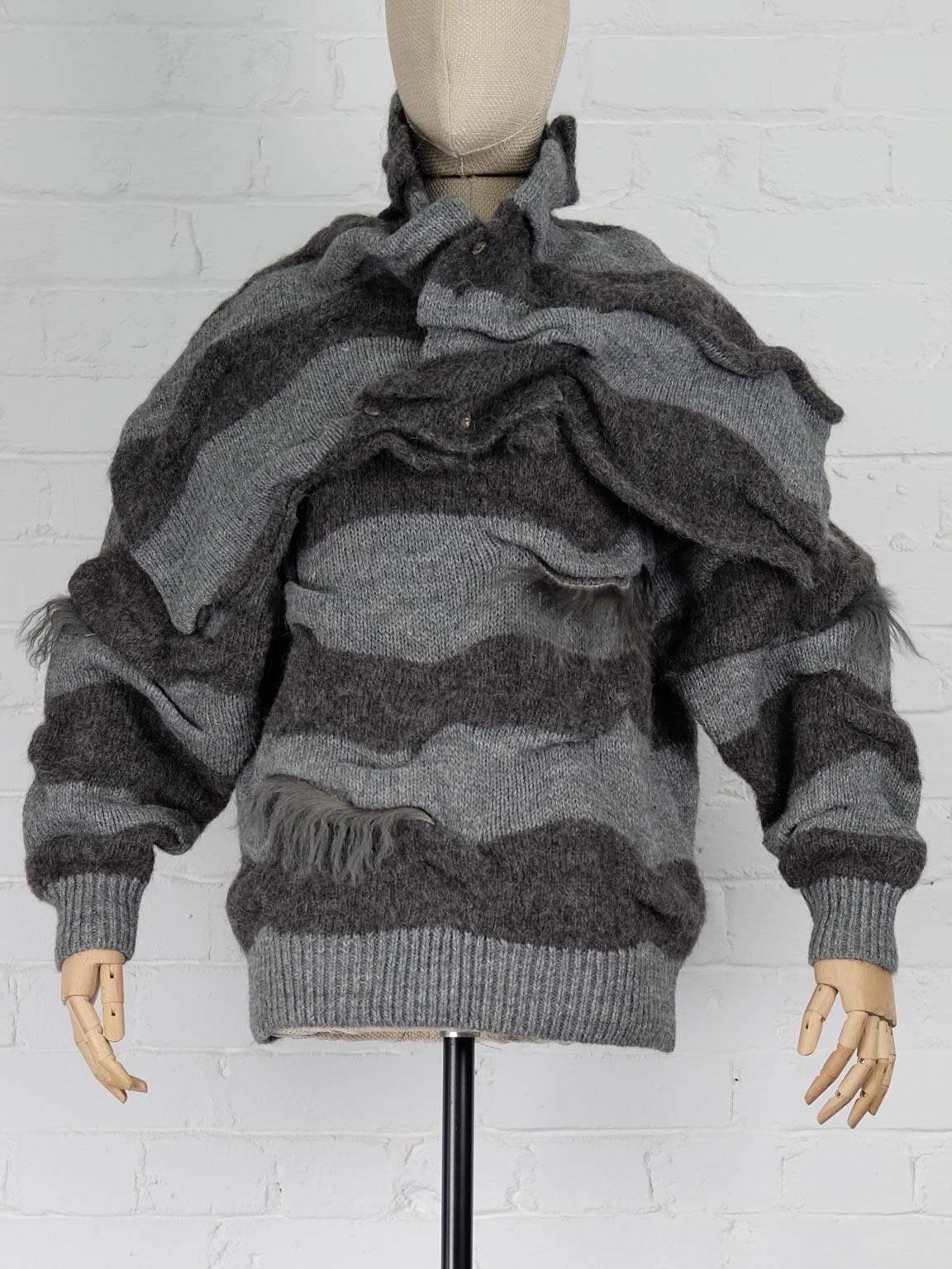 1980s Grey wool blend two piece striped jumper  featuring long sleeves, a ribbed hem and cuffs, a loose style, a detachable button fastening shawl and fur trims. 

Total Lenght 58cm
Bust 123cm
Shoulders 55cm
Sleeve 56cm