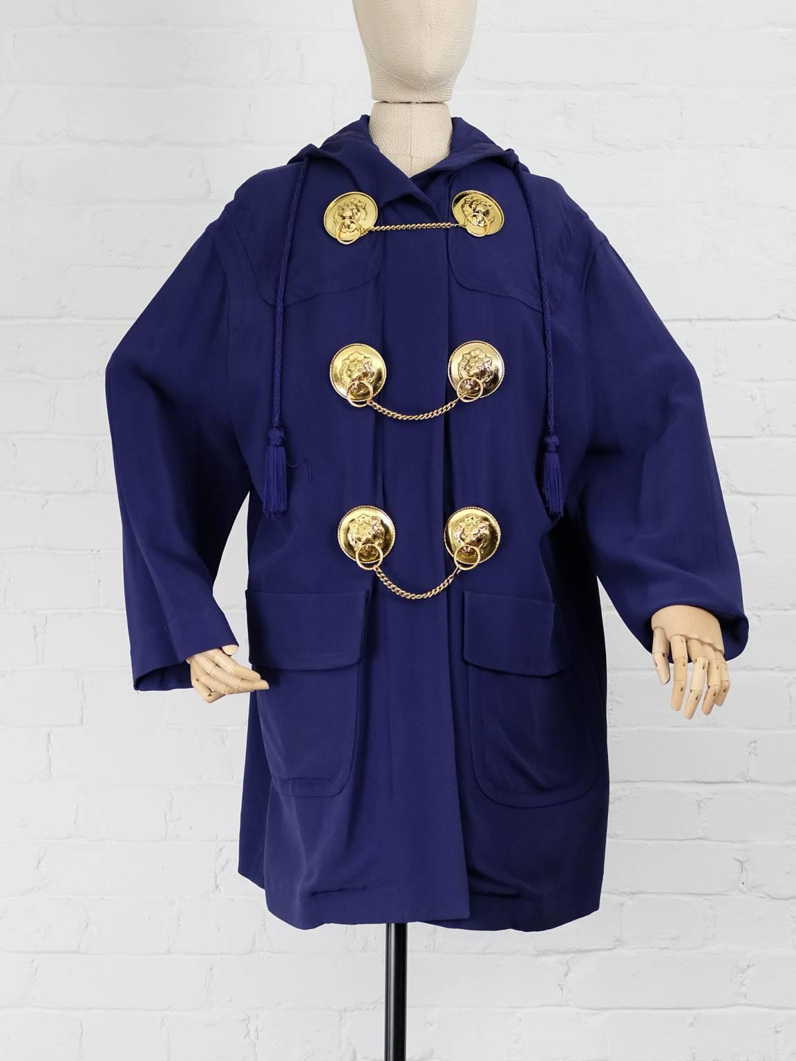 Purple medal embellished coat  featuring tassel detailing, a front zip fastening, chain trimming, front flap pockets, long sleeves, a mid-length and a drawstring hood. 

Total Lenght 95cm
Waist 130
Shoulders 50cm
