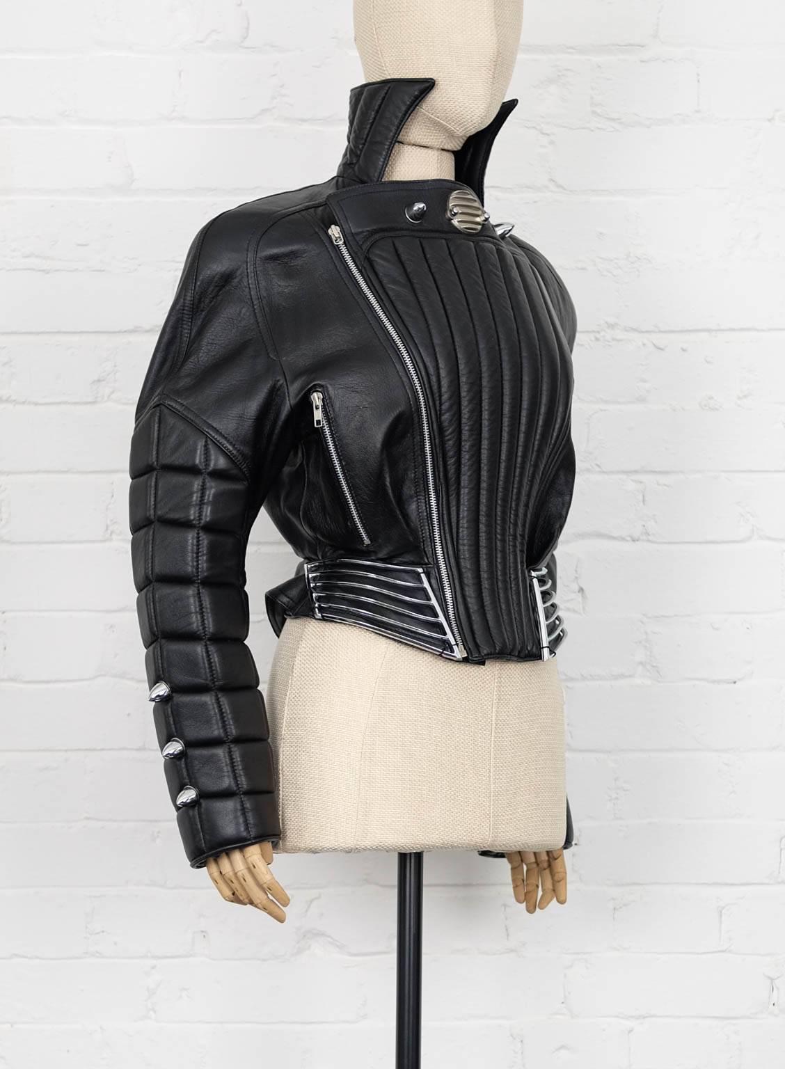 Black lamb skin leather padded bomber jacket from Thierry Mugler Vintage featuring notched lapels, long sleeves, zipped cuffs, a front zip fastening, a cropped length and spike stud accents. Circa 80's