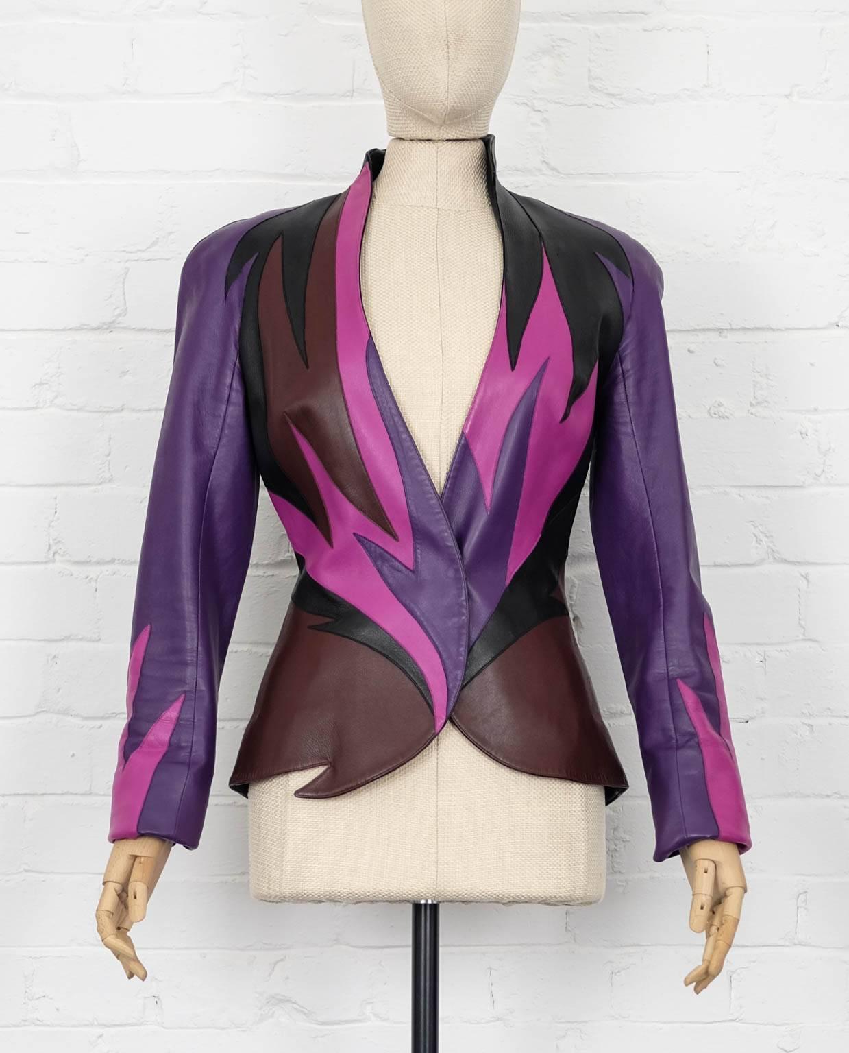 Purple, brown, black and pink leather flame leather jacket from Thierry Mugler Vintage featuring a concealed front fastening, a stand up collar, long sleeves with slits at the cuffs and a colour blocked flame design to the front. Excellent