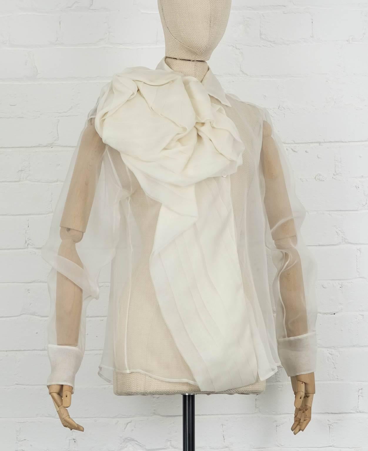Circa 2004 White bow sheer blouse from Christian Dior by John Galliano featuring a classic collar, a front button fastening, long sleeves, button cuffs and a ruffled design. Silk 100%

Never worn before.

Shoulder 45cm
Sleeve length 63 cm