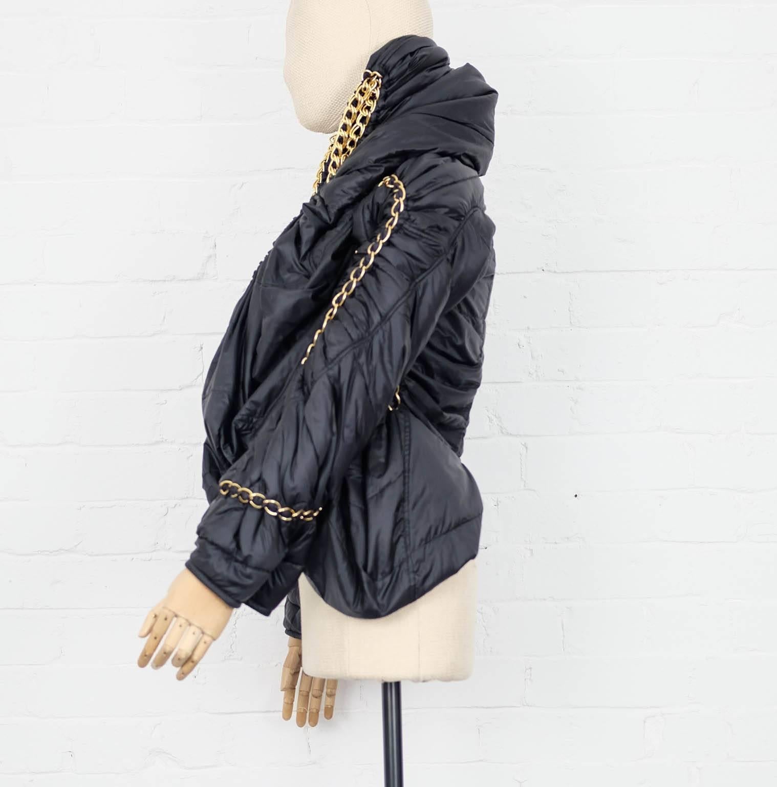Junya Watanabe for Comme Des Garçons black draped puffer coat with gold chain trim - runway 2009 featuring a draped open front, long sleeves and a gold-tone chunky chain detail running across the piece. In excellent condition.


Mesurements:
Bust: