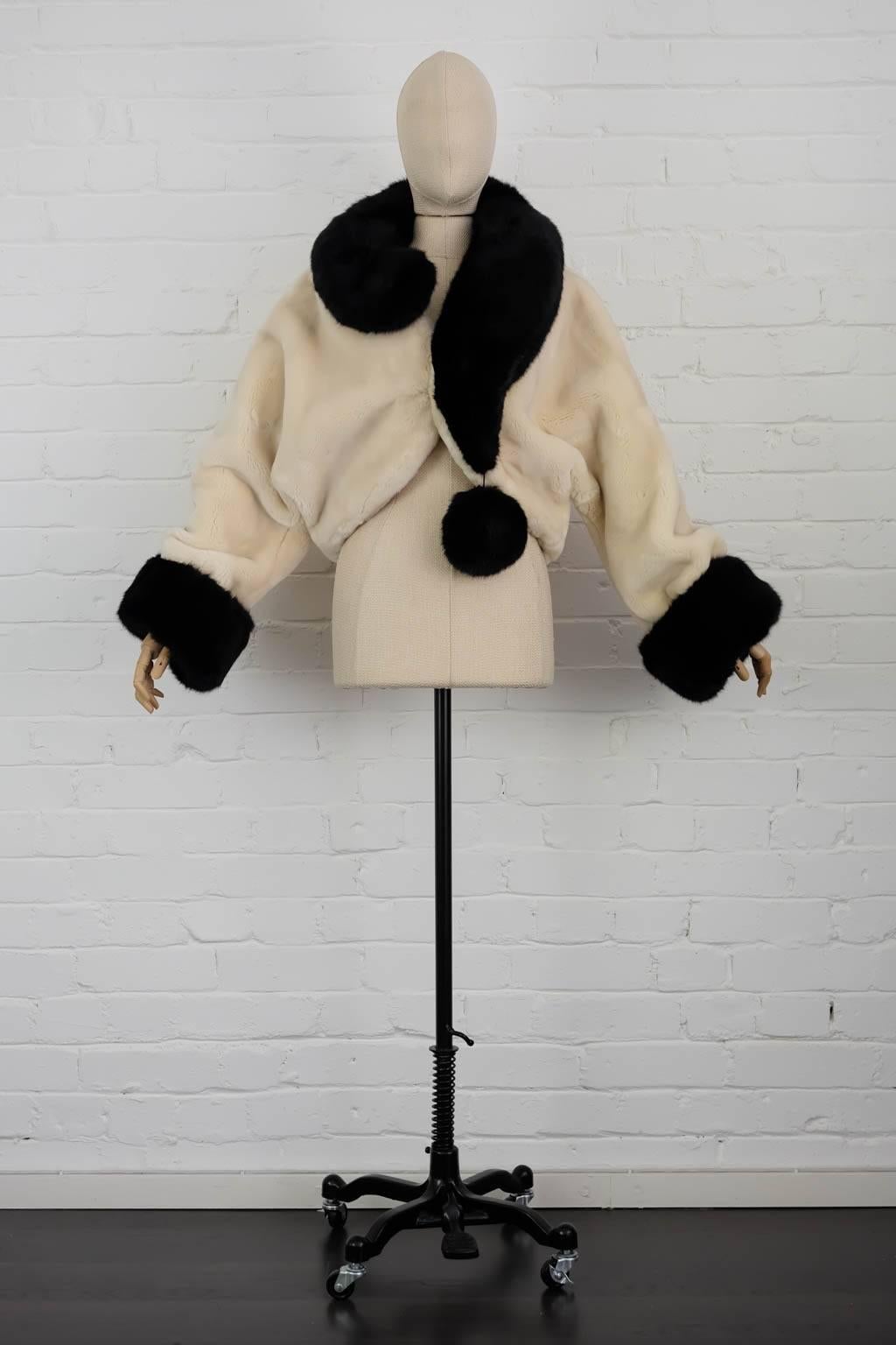1994 White and black "Question Mark" faux-fur jacket featuring a curved peak, a concealed front fastening, long sleeves, a cropped length, a ribbed hem and a hanging pompom detail. 
Size 44IT
Total Length 48cm
Shoulders aprox 60cm
Sleeve