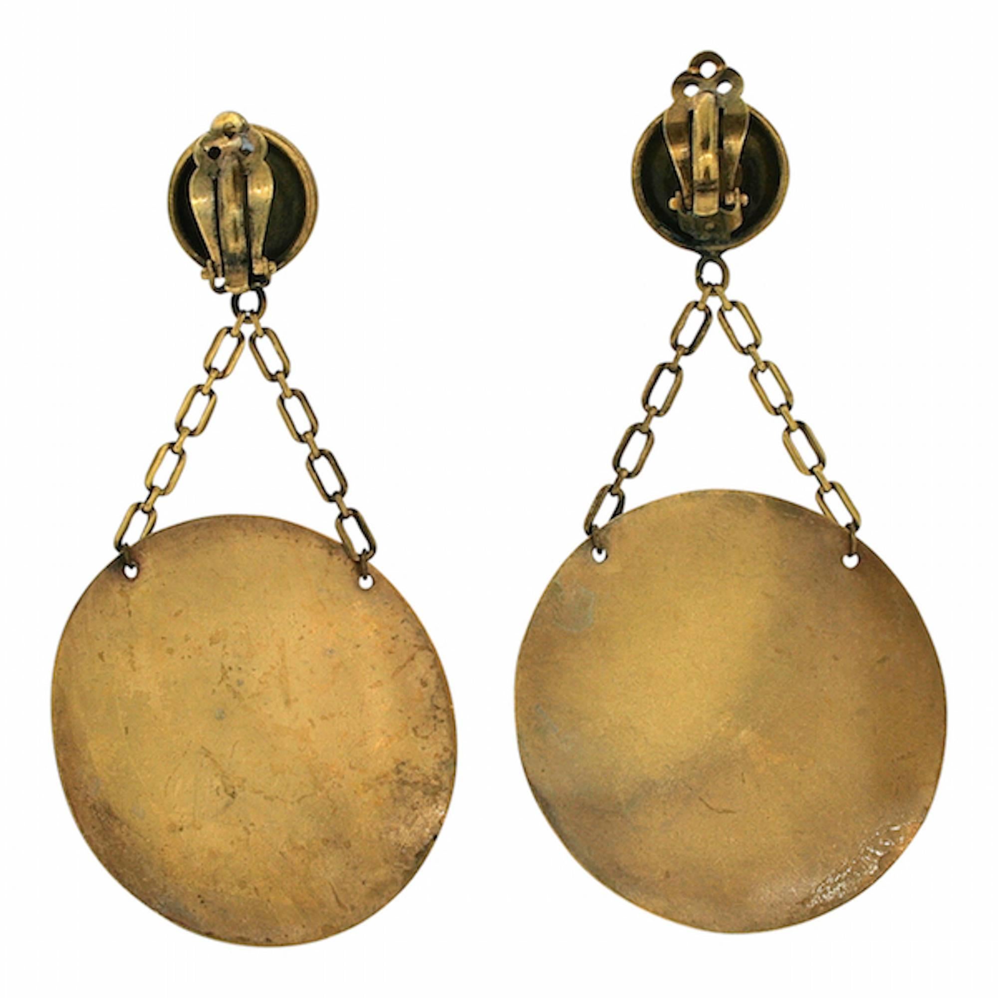 Featuring a magnificent design, these earrings date from the 1950s and are by Joseff of Hollywood. They are clip on. 

Condition Report:
Very Good - Some wear to the gilt metal plating around the outer edge of the discs. This is consistent with age