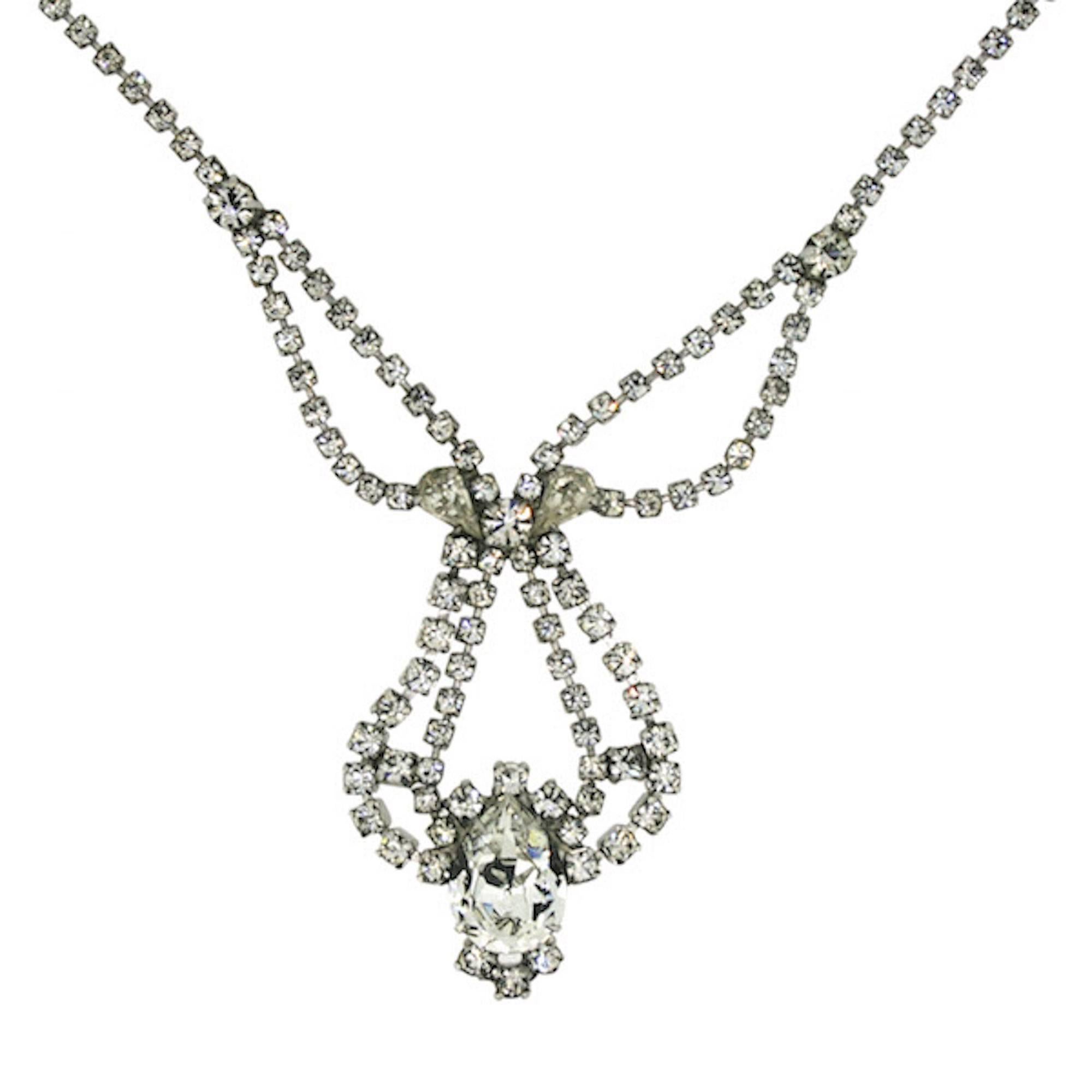 This is a glamorous diamante necklace by American costume jewellery manufacturer, Weiss. It dates from the 1960s.

Condition Report
Very Good - Minor rubbing to the silver tone metal on the reverse of the necklace due to wear over the decades. This