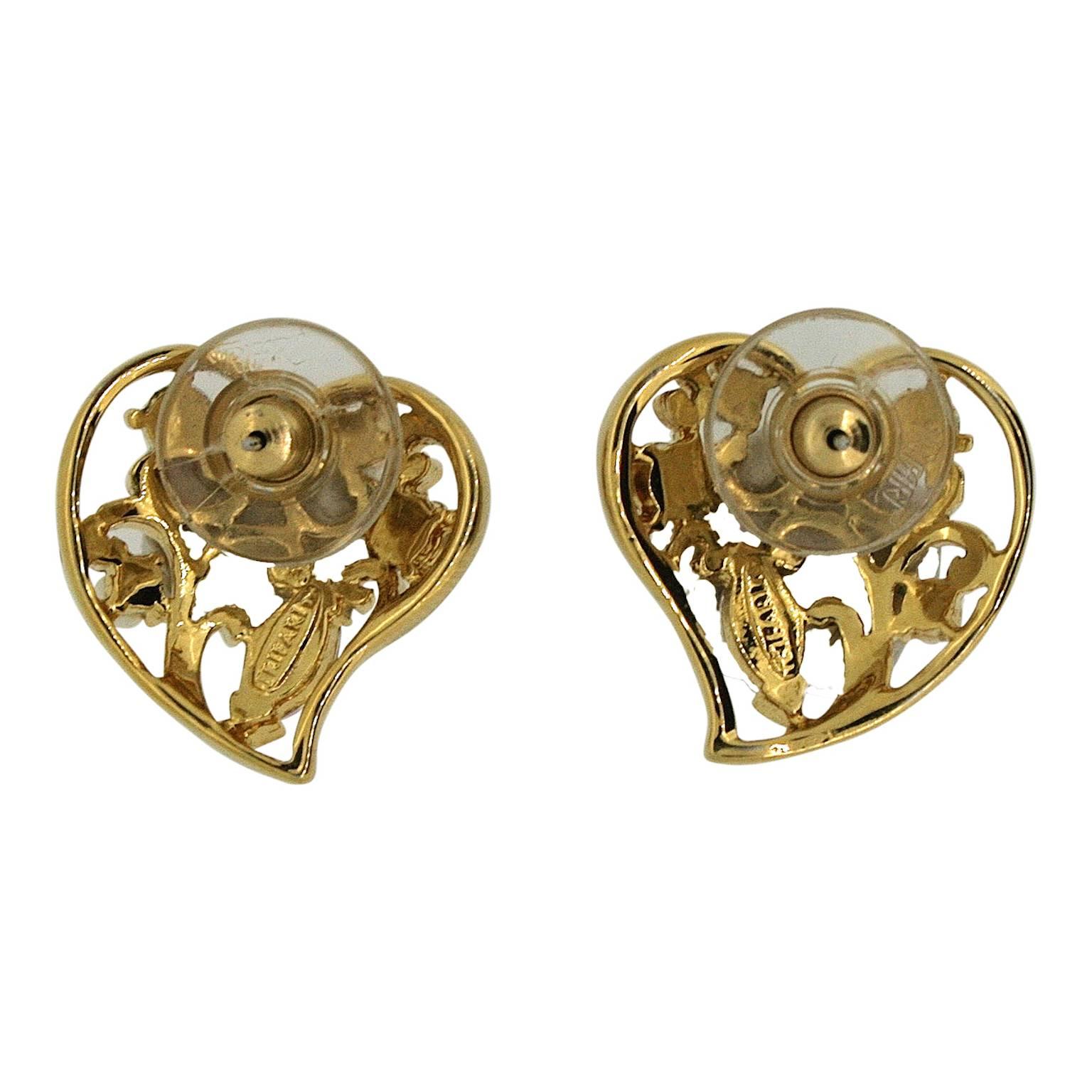 These pretty earrings are for pierced ears and were made in the 1970s by Trifari.

Condition Report:
Excellent

The Details...
These gold tone earrings feature an open-work 'heart' design. They are detailed with round and navette, lilac and pink