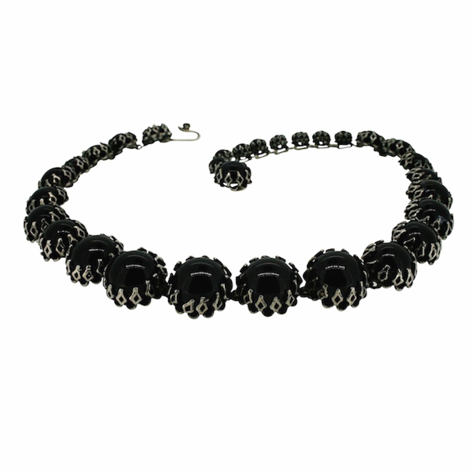 This necklace dates from the 1950s. It was created by the American company, Kramer, for Christian Dior. 

Condition Report:
Excellent

The Details...
This necklace is silver tone. It fastens with a 'hook and eye' mechanism.  All of the stones are