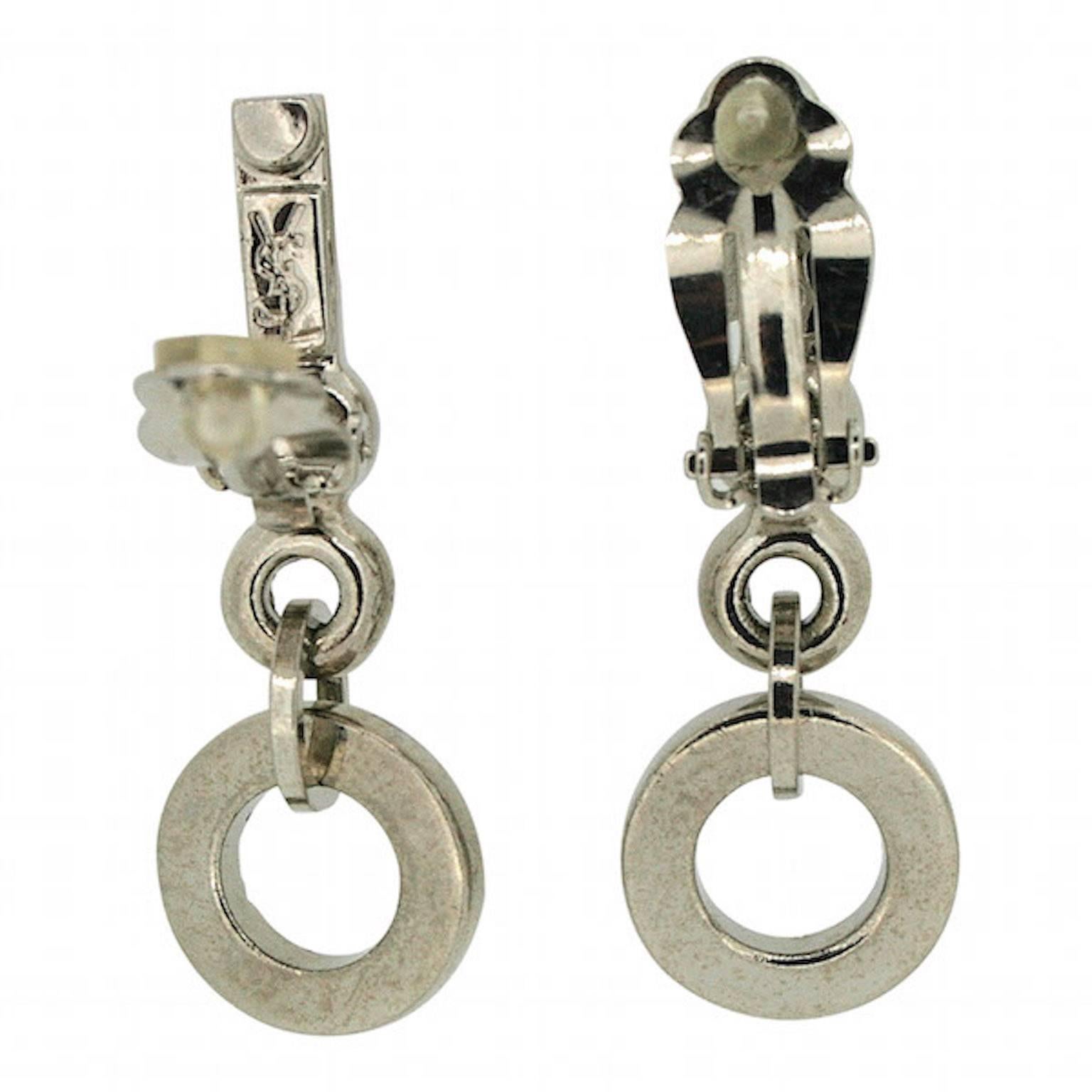 Magnificent and 'high fashion', these earrings are well-crafted example by Yves Saint Laurent. They date from the 1980s and are clip on.
Condition Report:
Excellent

The Details...
These silver tone metal earrings feature an Art Deco style design.