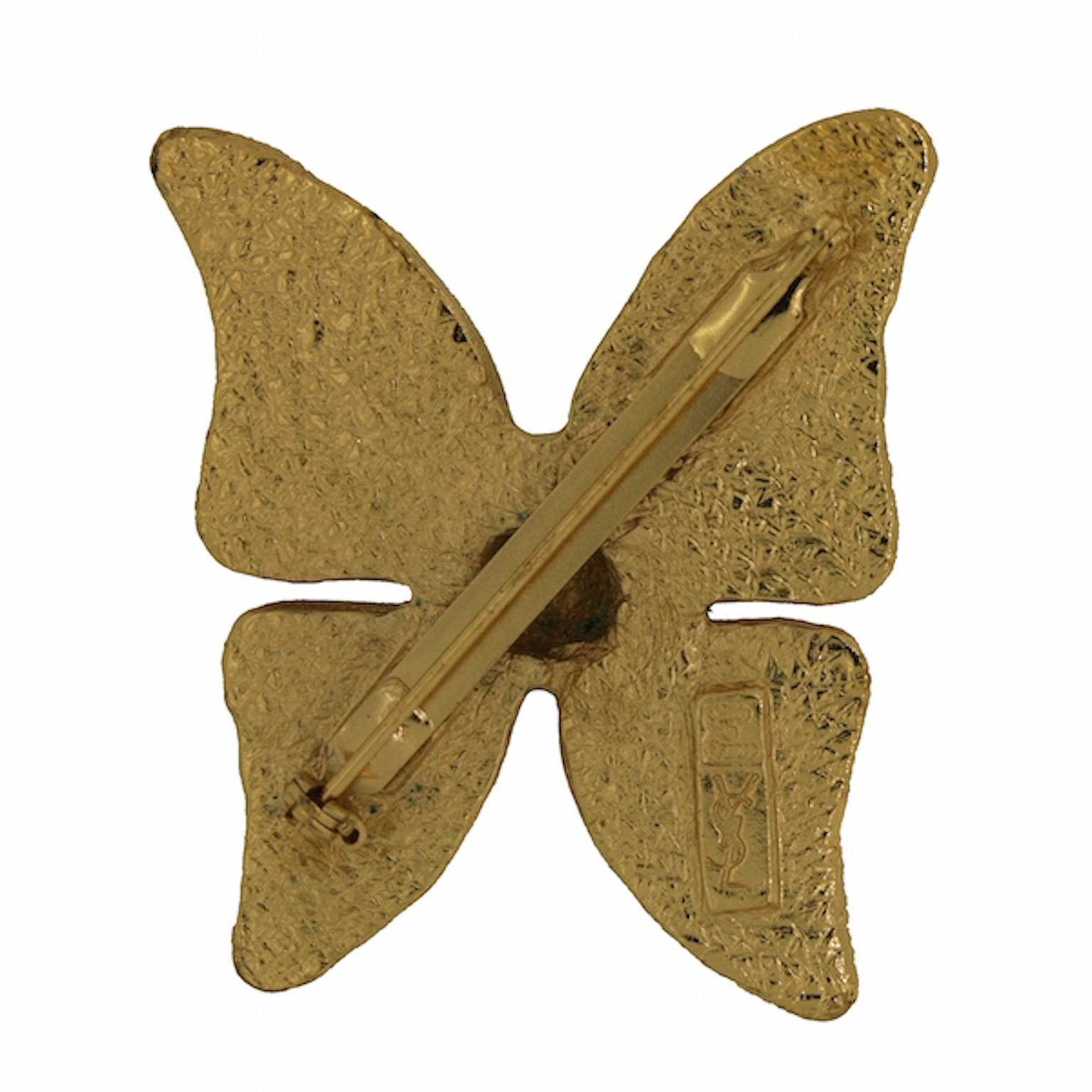 Beautiful French styling can be found in this butterfly brooch by Yves Saint Laurent. It dates from the 1980s.
Condition Report:
Excellent

The Details...
This brooch features an stylised gold tone butterfly detailed with purple enamelling. The