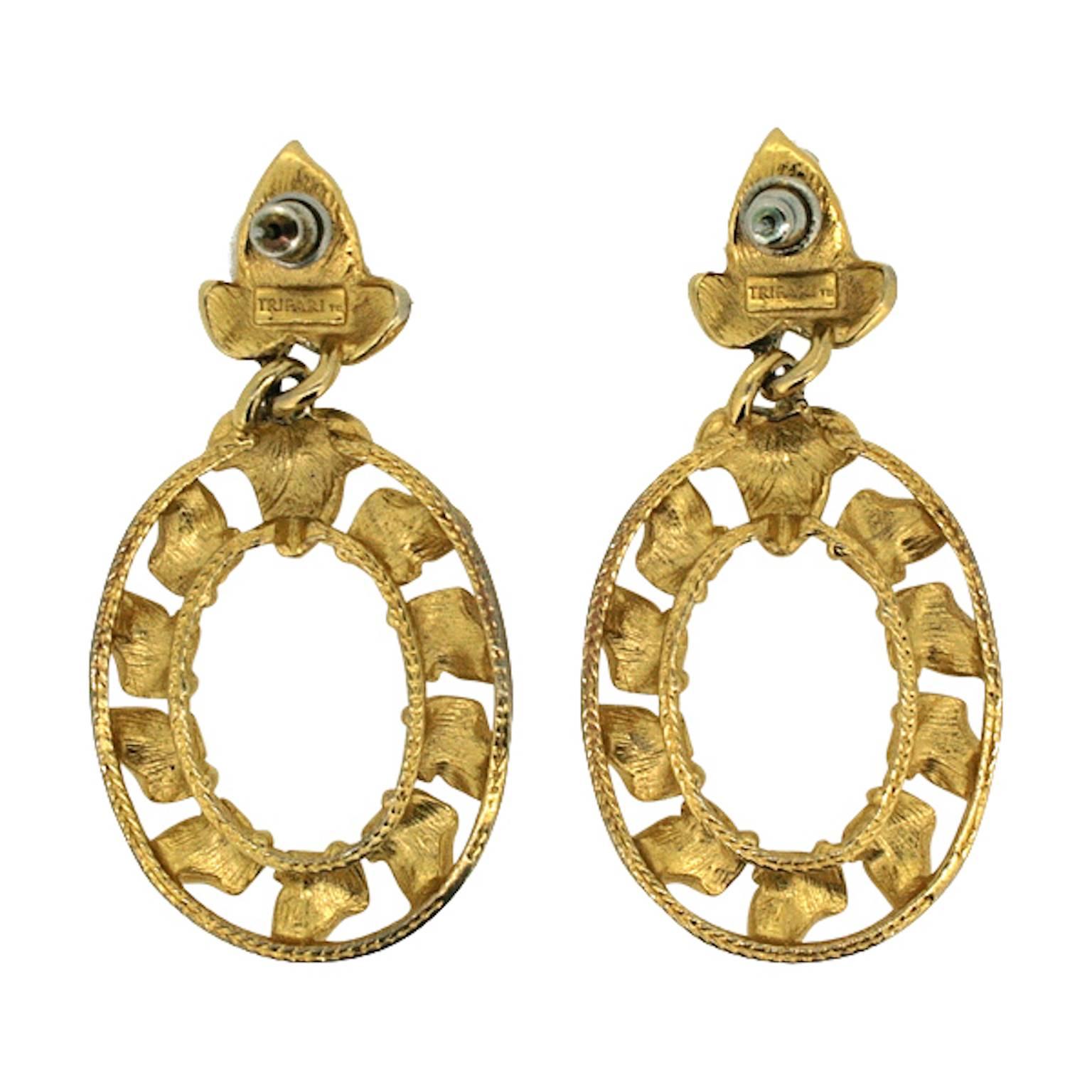 These glamorous drop earrings are for pierced ears and were made in the 1980s by Trifari.
Condition Report:
Excellent
The Details...
These gold tone earrings feature an 'Ivy leaf' motif in a hoop style design. They measure 3cm x 5cm. The earrings