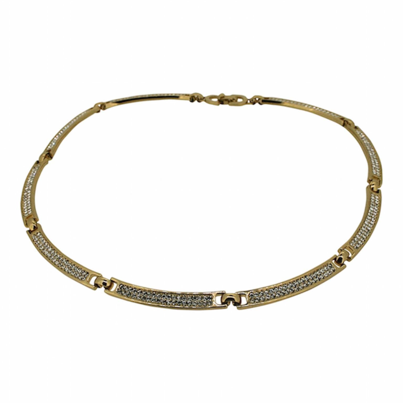This classic necklace is by Christian Dior. It was made in the 1980s in Germany for the French fashion house. 
Condition Report:
Excellent
The Details...
This gold plated necklace is detailed with flat panels Each panel is ecrusted with small,