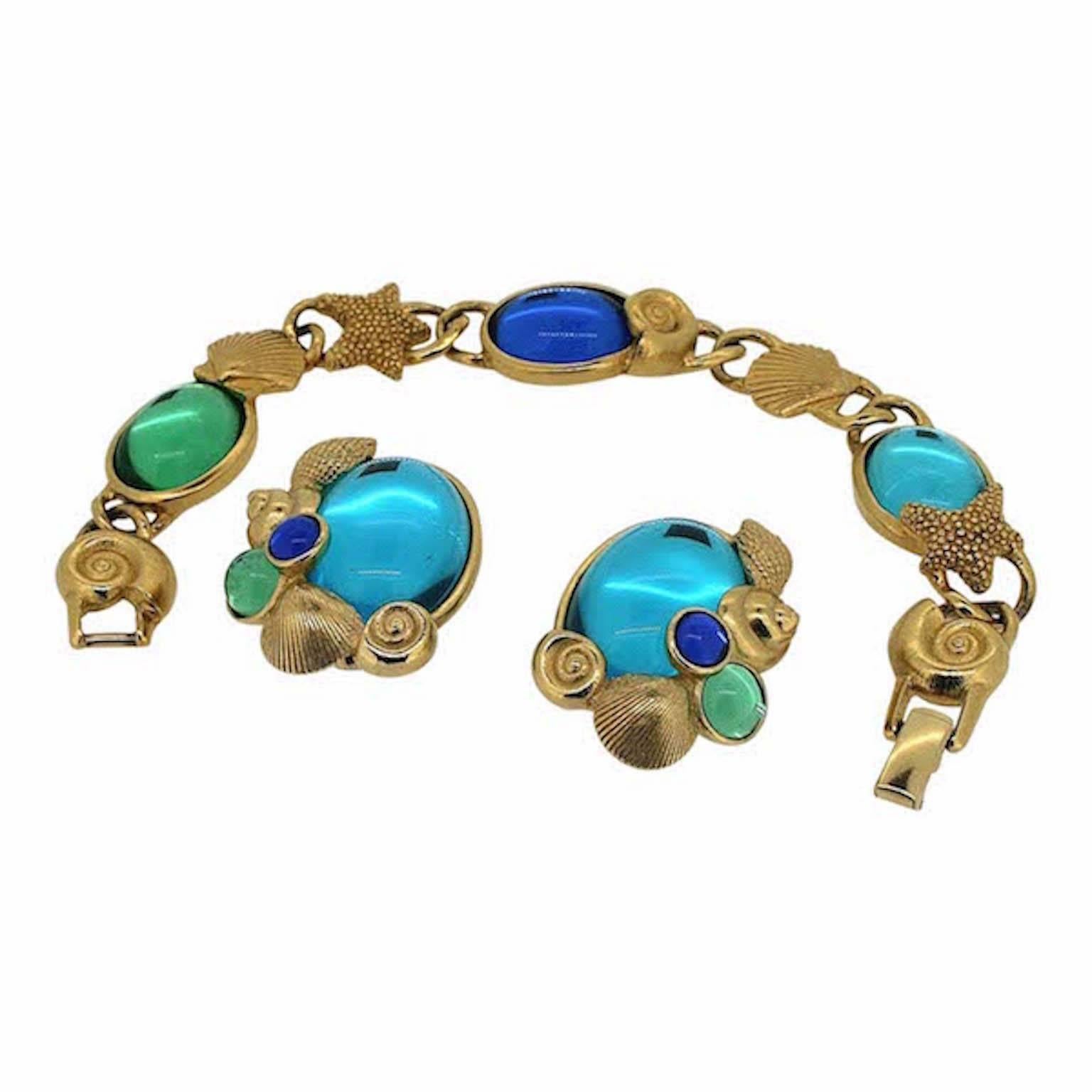 This whimsical and pretty jewellery set was created by Kunio Matsumoto for Trifari in the late 1970s. 
Condition Report:
Excellent
The Details...
This gold tone metal jewellery set features a bracelet and clip on earrings. Each item is detailed with