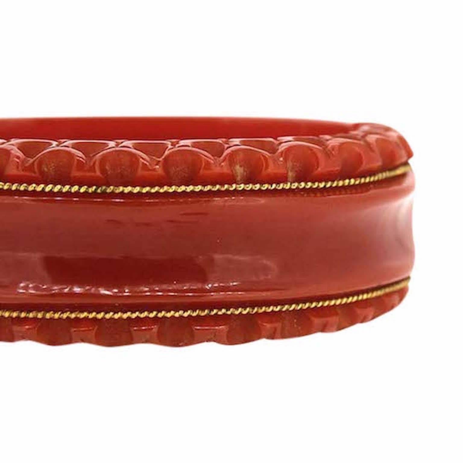 Featuring a burnt orange hued Bakelite and gilt metal detailing, this bangle dates from the 1940s.
Condition Report:
Very Good - Some discolouration to the metal findings on this bangle, consistent with age and use. This is only visible upon very