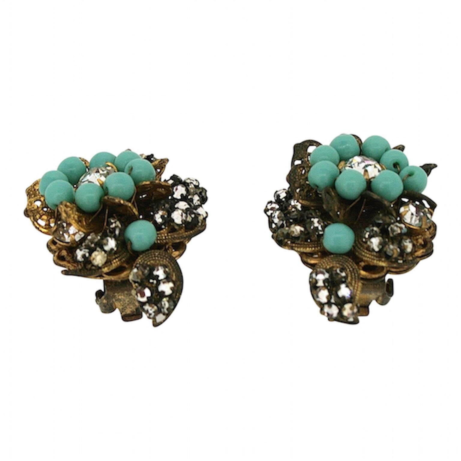 These remarkable clip on earrings are a beautiful example of the costume jewellery produced in the 1950s by the Miriam Haskell company. 
Condition Report:
Good - Some wear to the gilt metal surface of one earring consistent with age and use. This