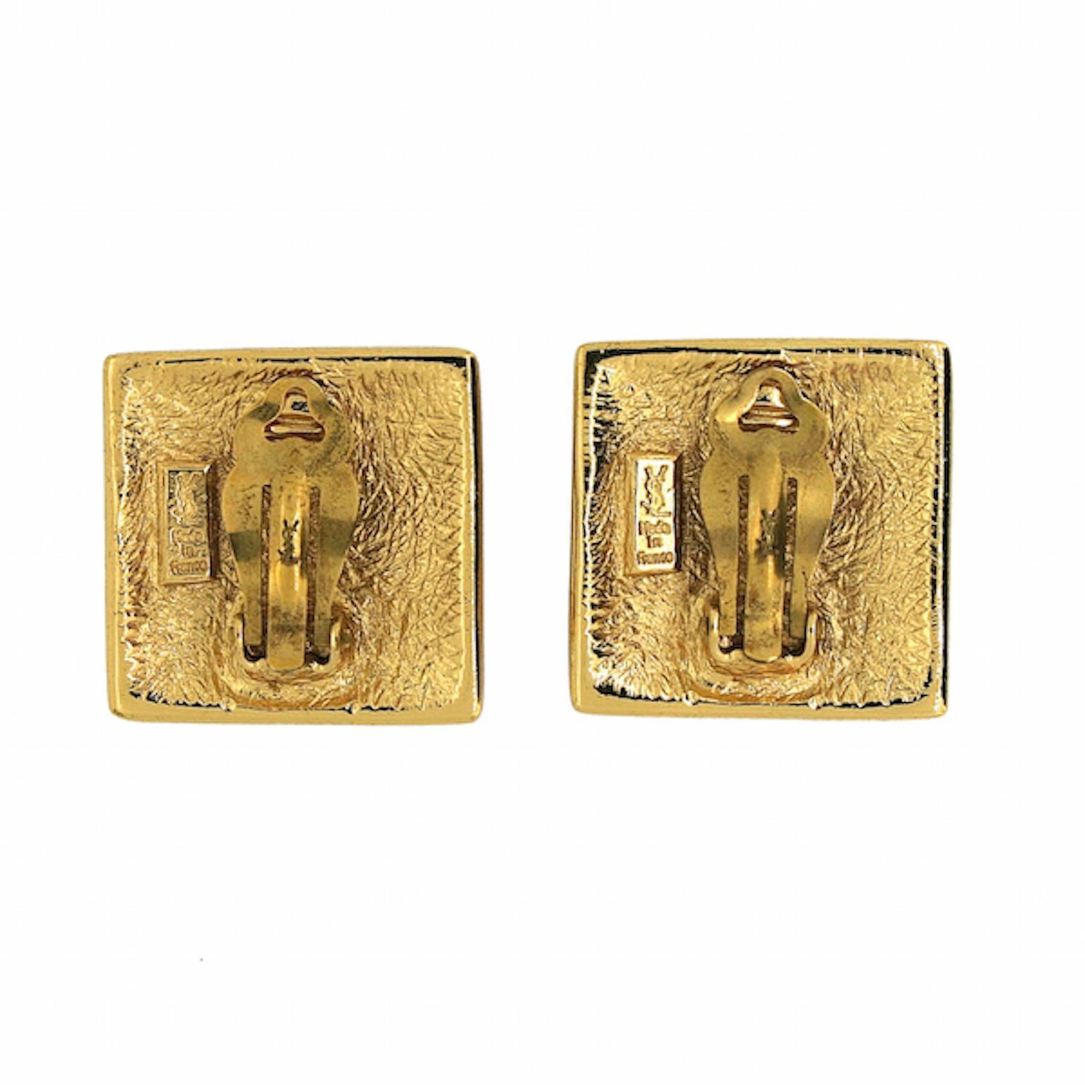 Magnificent and 'high fashion', these earrings are well-crafted example by Yves Saint Laurent. They date from the 1980s and are clip on.
Condition Report:
Excellent
The Details...
These square shaped, gold plated earrings feature a floral design