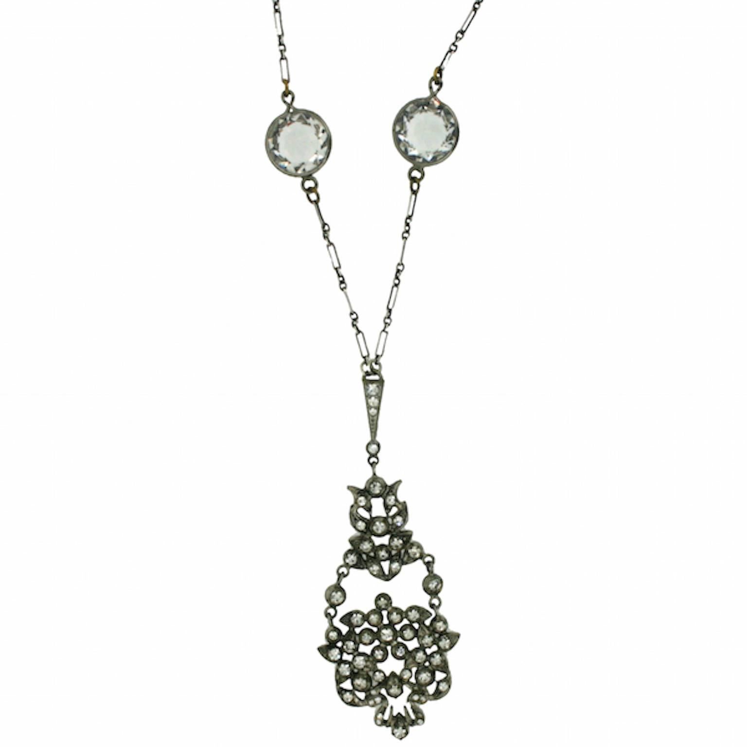 Delicate and enchanting, this piece dates from the Edwardian era and is unsigned. 
Condition Report: 
Excellent
The Details...
This silver tone metal necklace features a long and short open link chain. Set within the chain are two, large, round rock