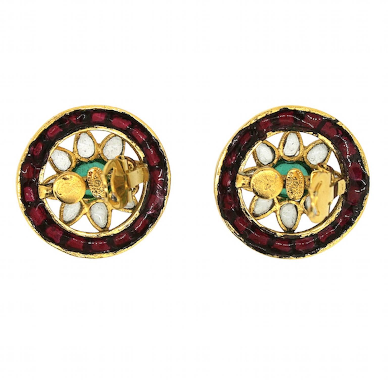 These fabulous earrings feature high quality poured Gripoix glass. They were created by Chanel in 1994. 
Condition Report:
Excellent
 The Details...
These gold plated earrings feature a flower design created from poured red, green and transparent