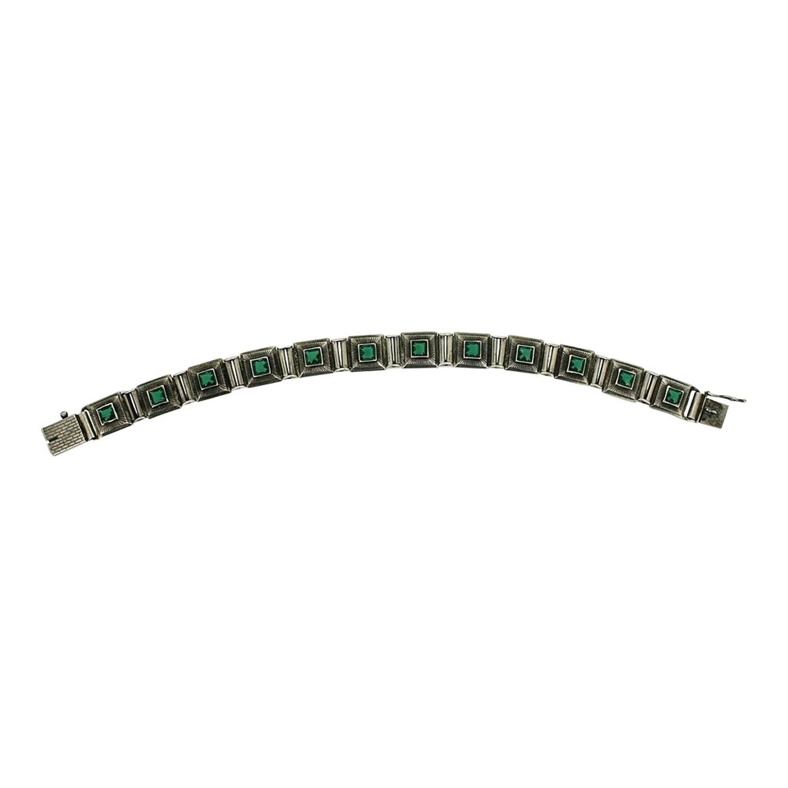 This vibrant bracelet dates from the 1920s and is unsigned. It features a typically Art Deco design, which can be enjoyed for centuries to come. 
Condition Report:
Very Good - A tiny chip to the faceting on one glass stone. This is only visible upon